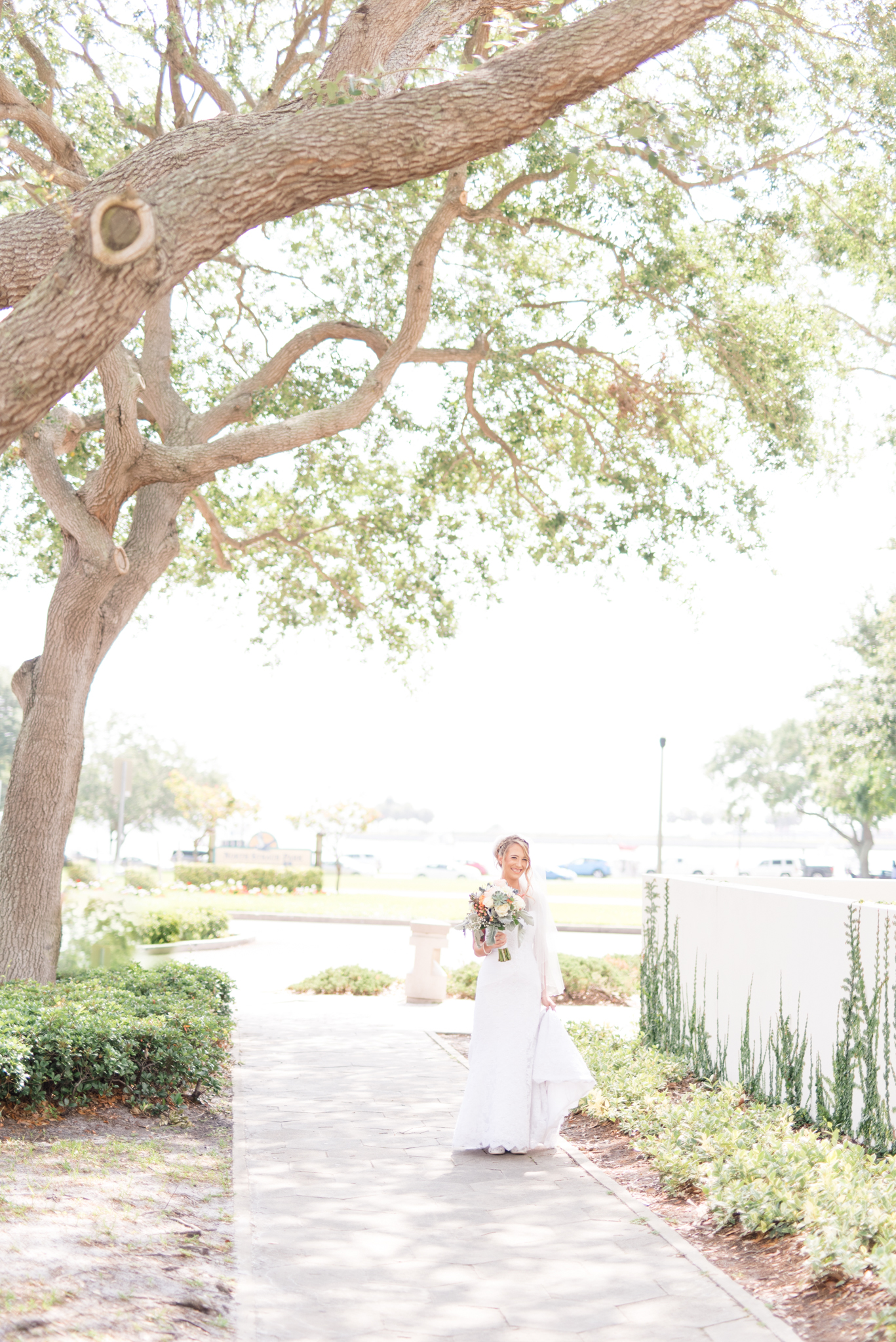 Bride walks along sidewalk.