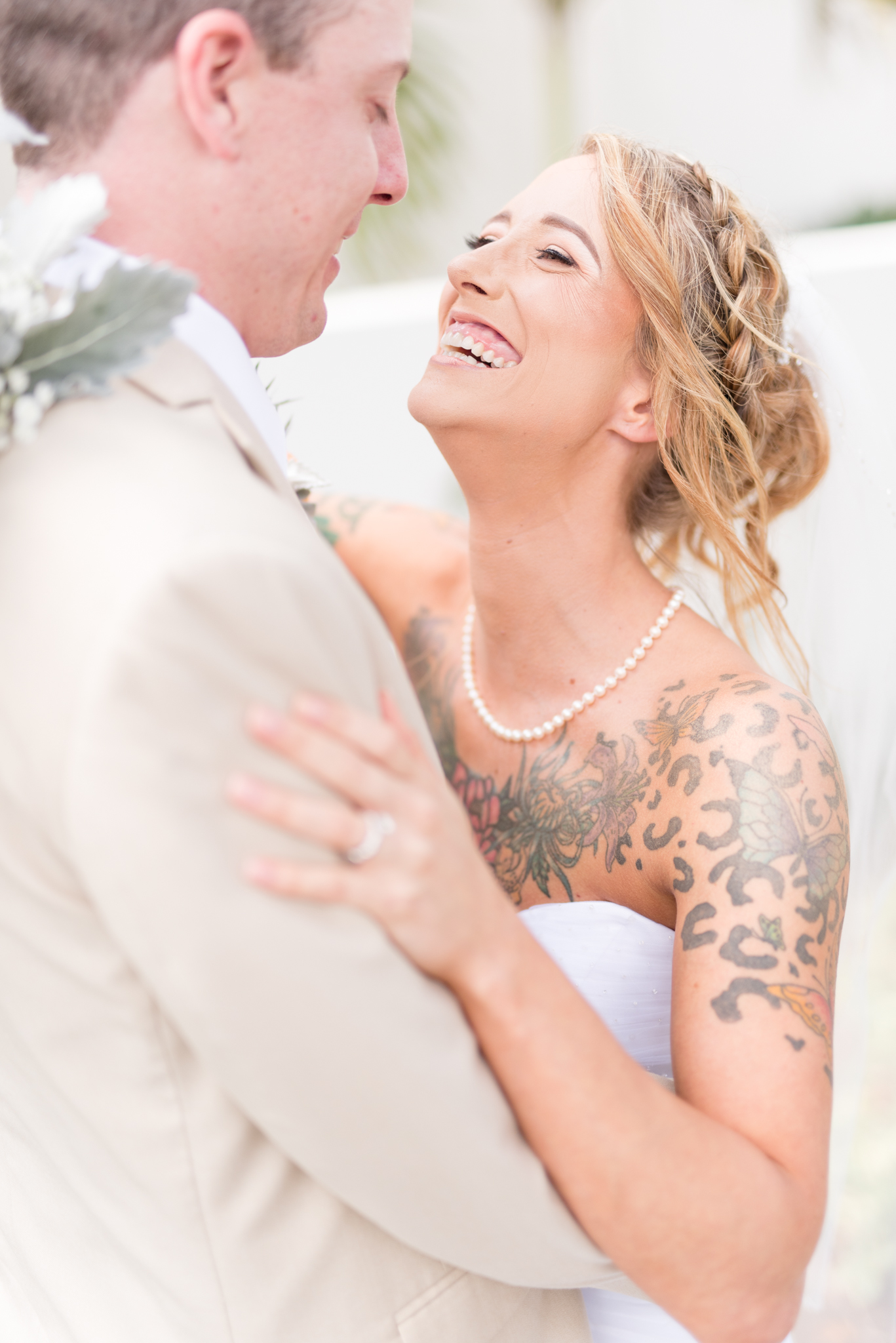 Bride laughs with groom.