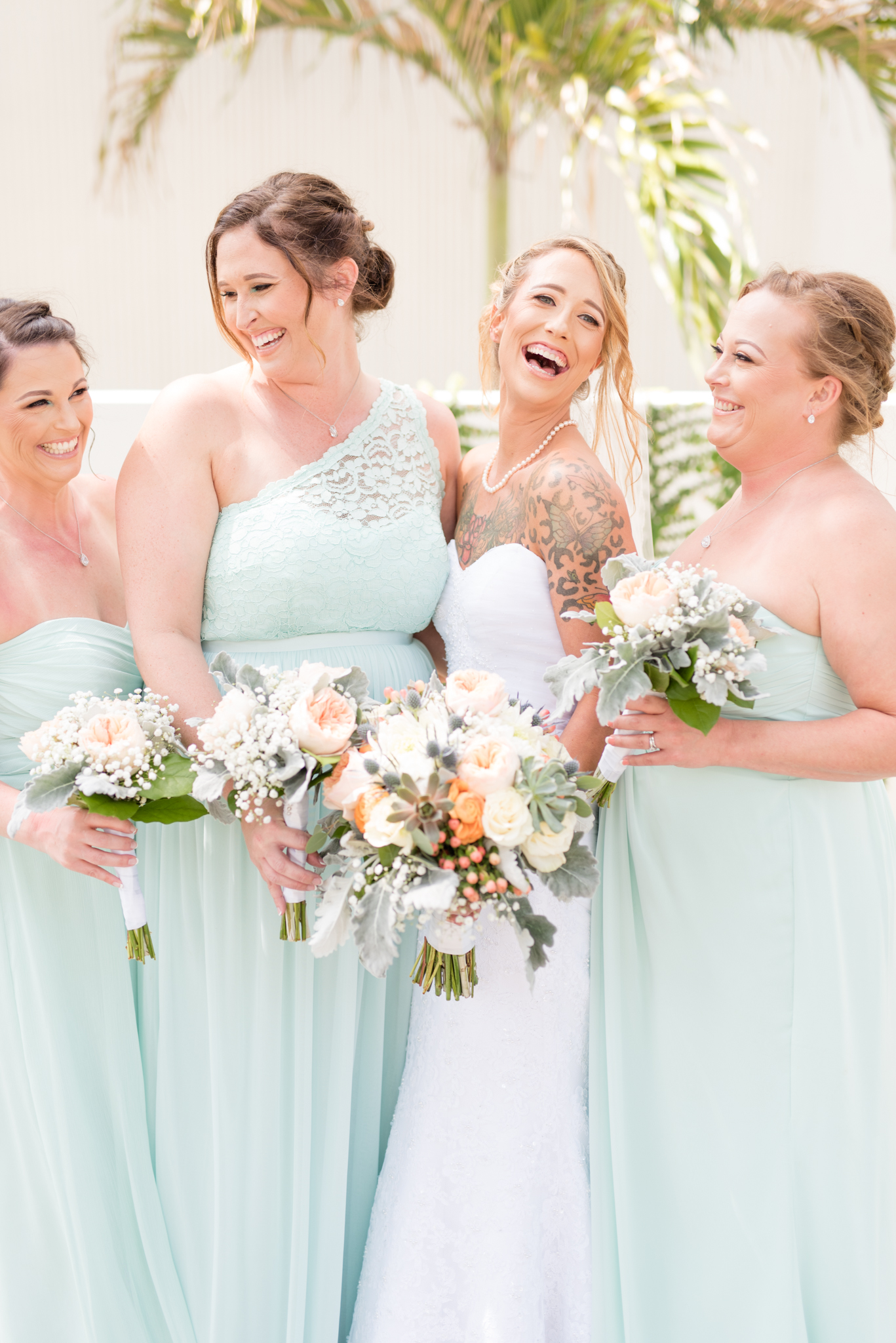 Brde laughs while standing with bridesmaids.