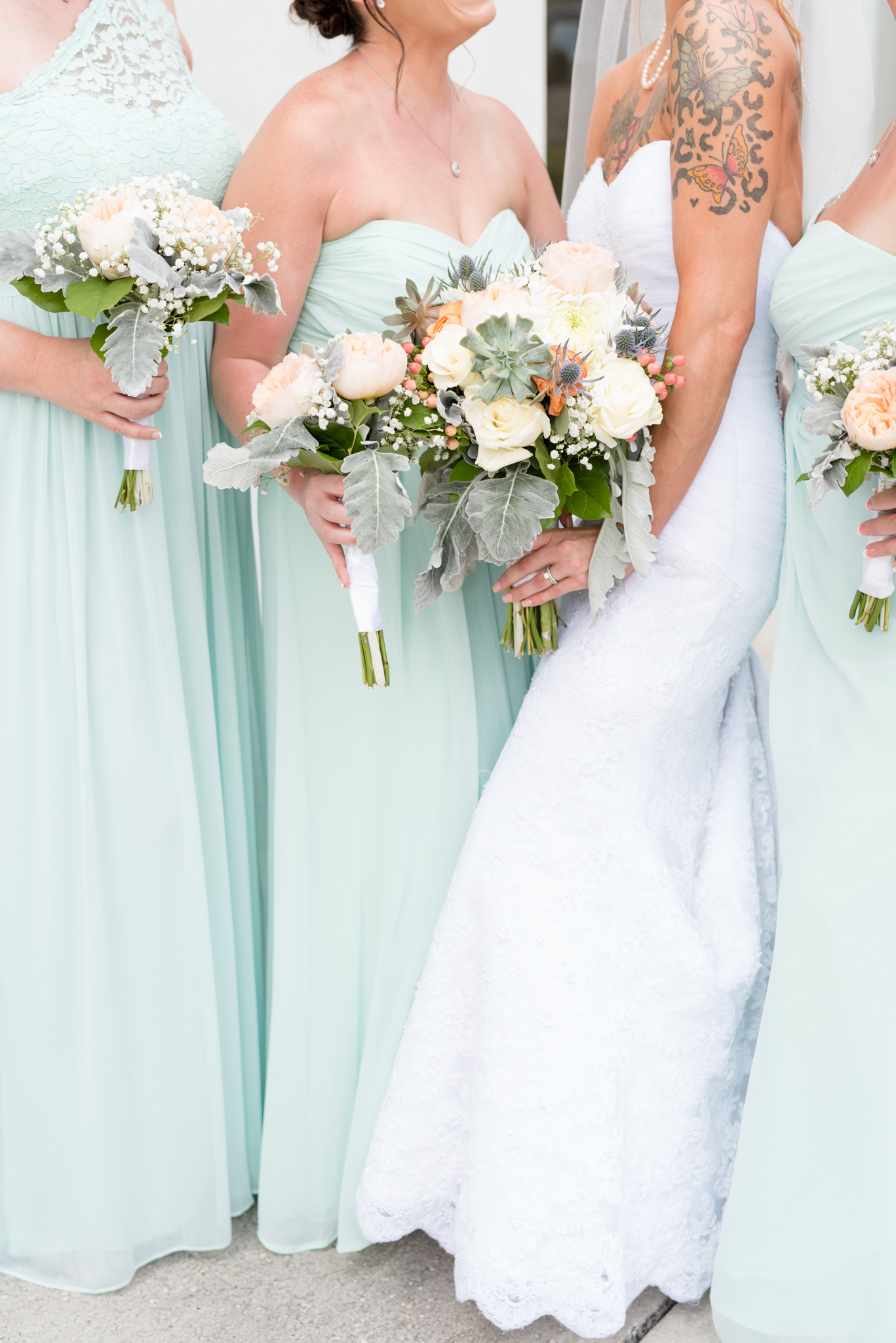 Bridal party holds bouquets.