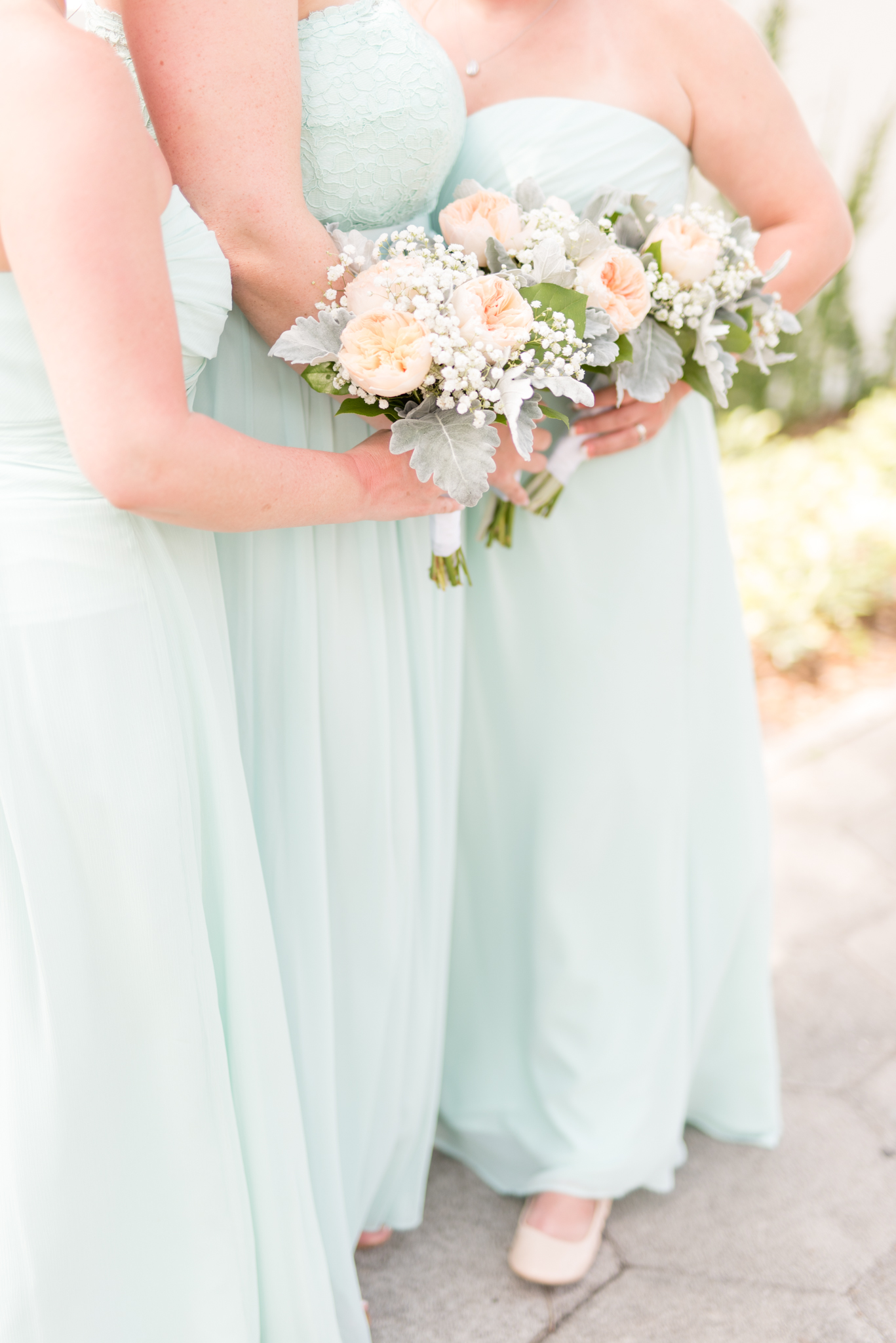 Bridemaids hold bouquets.