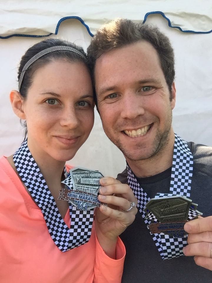 Couple holding medals.