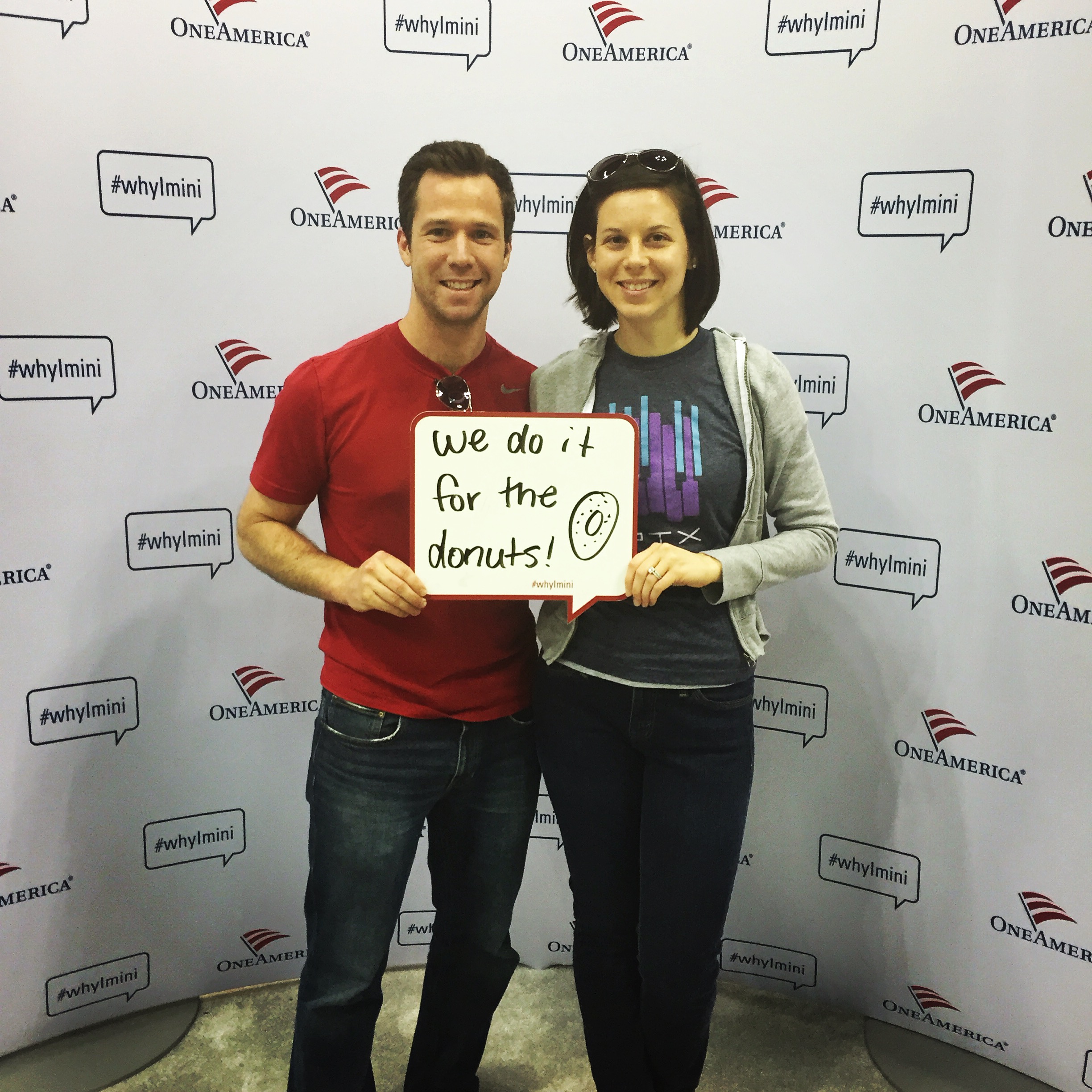 Couple holding sign.