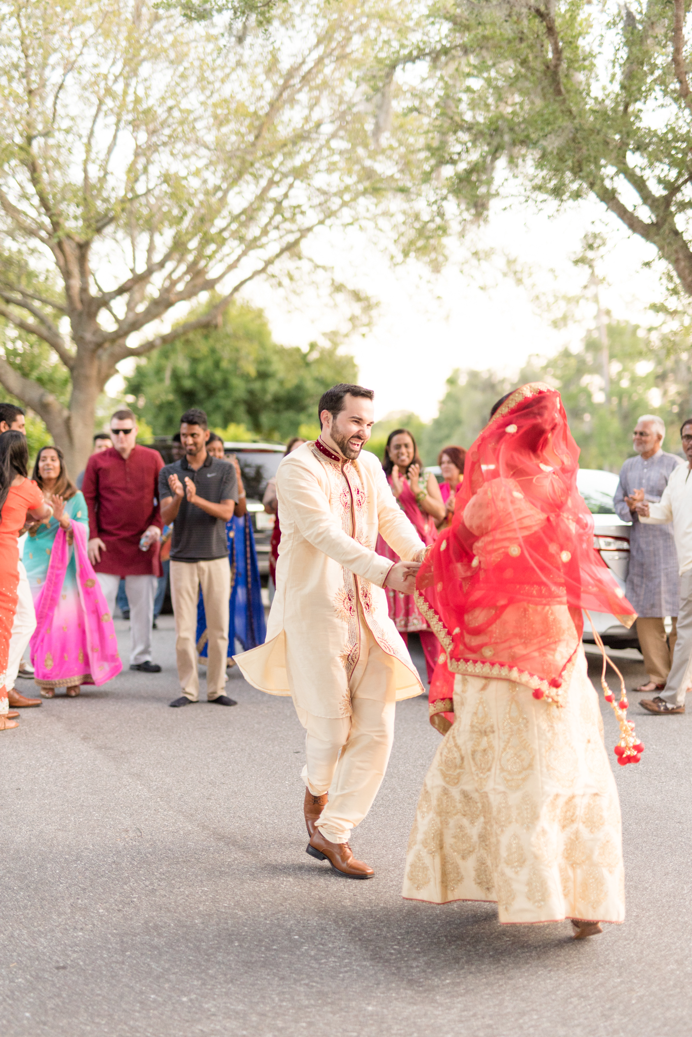 Bride and groom dance in street.