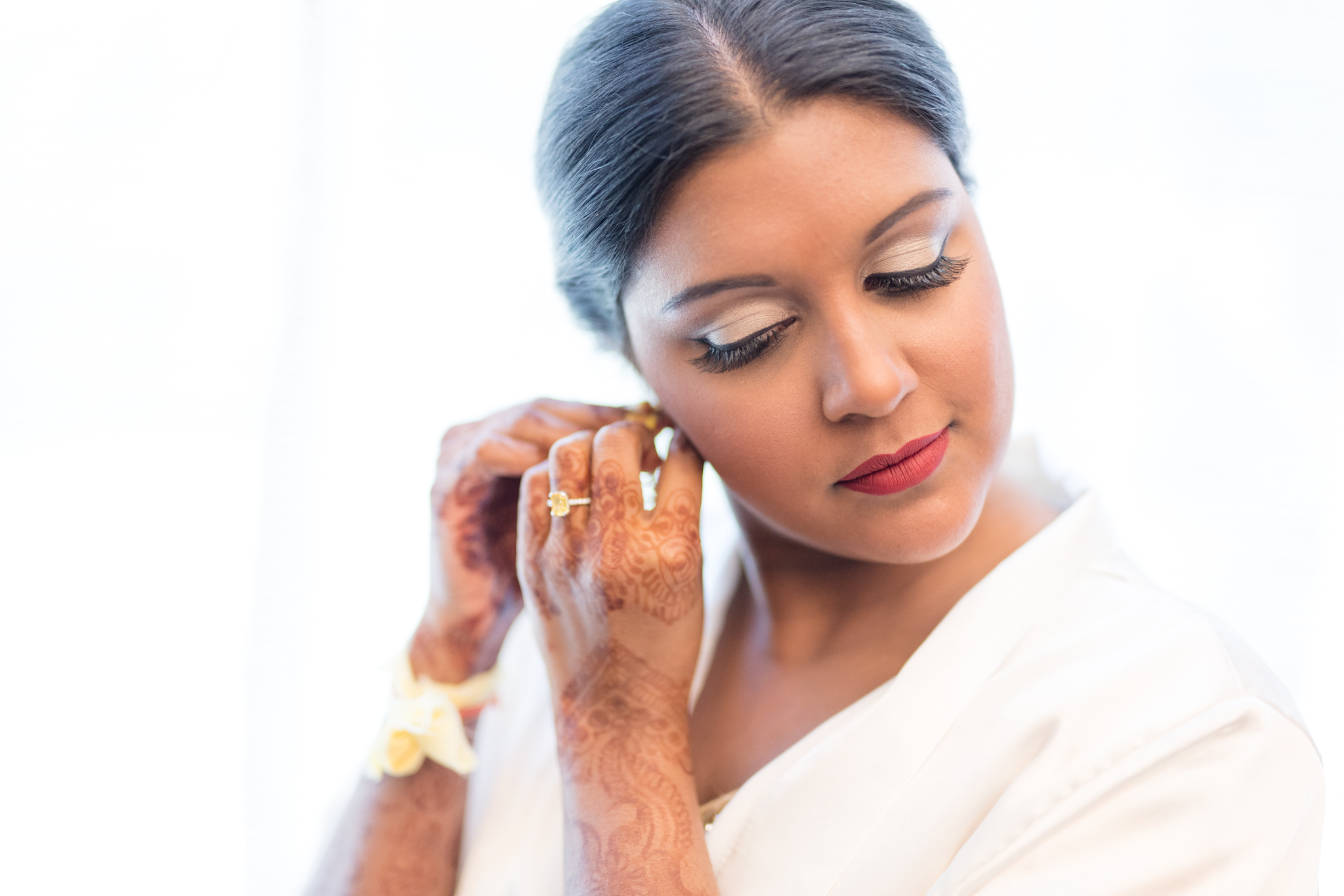 Bride puts on earrings.