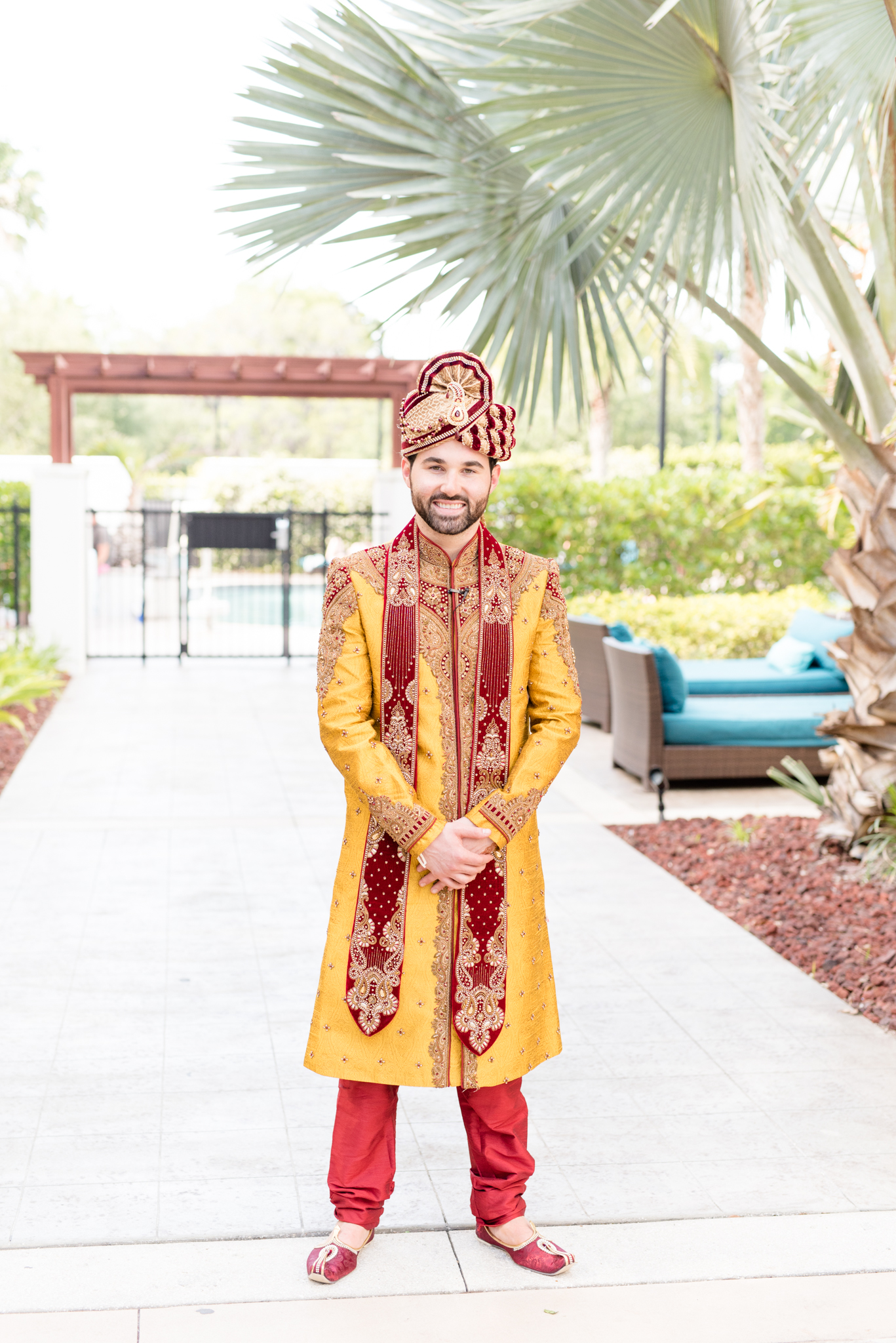 Groom smiles at camera.