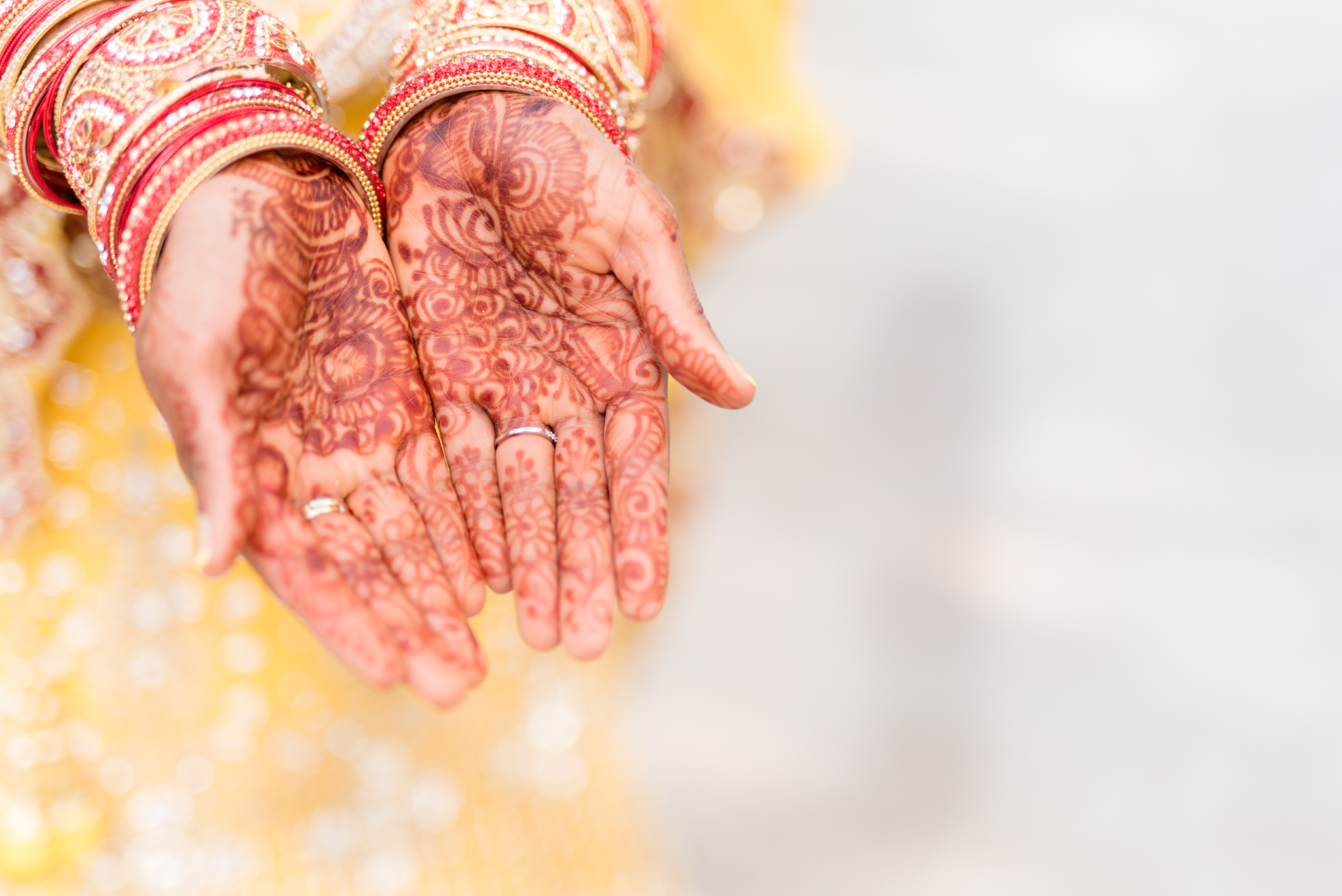 Bride holds out her hennaed hands.