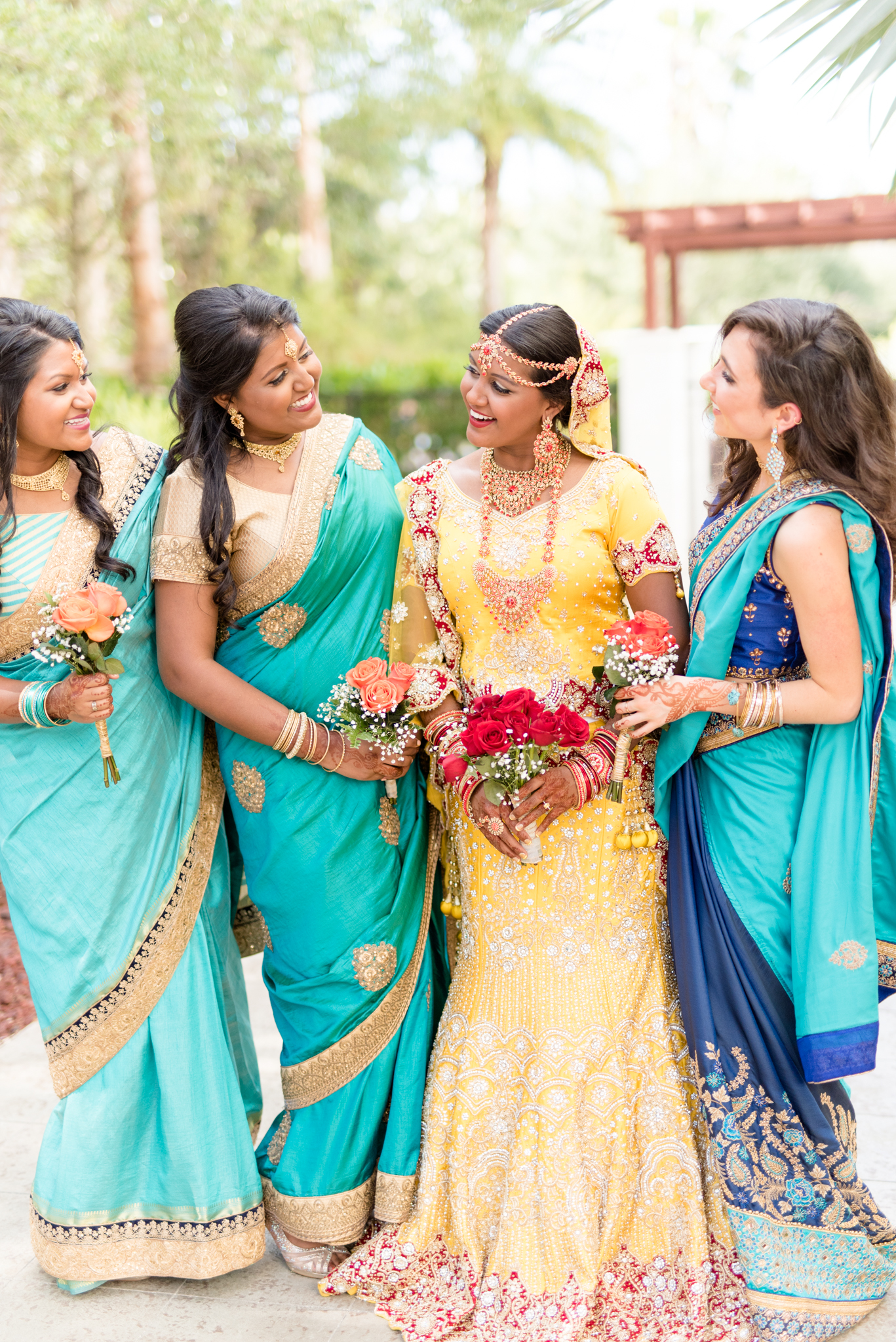 Bride laughs with her bridal party.