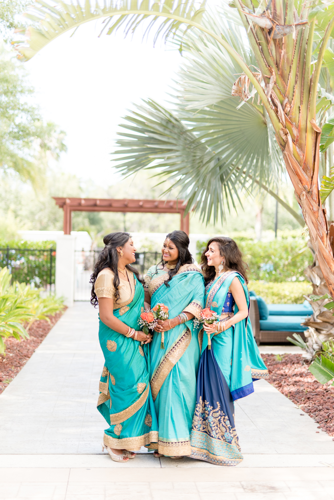 Bridesmaids smile and laugh together.