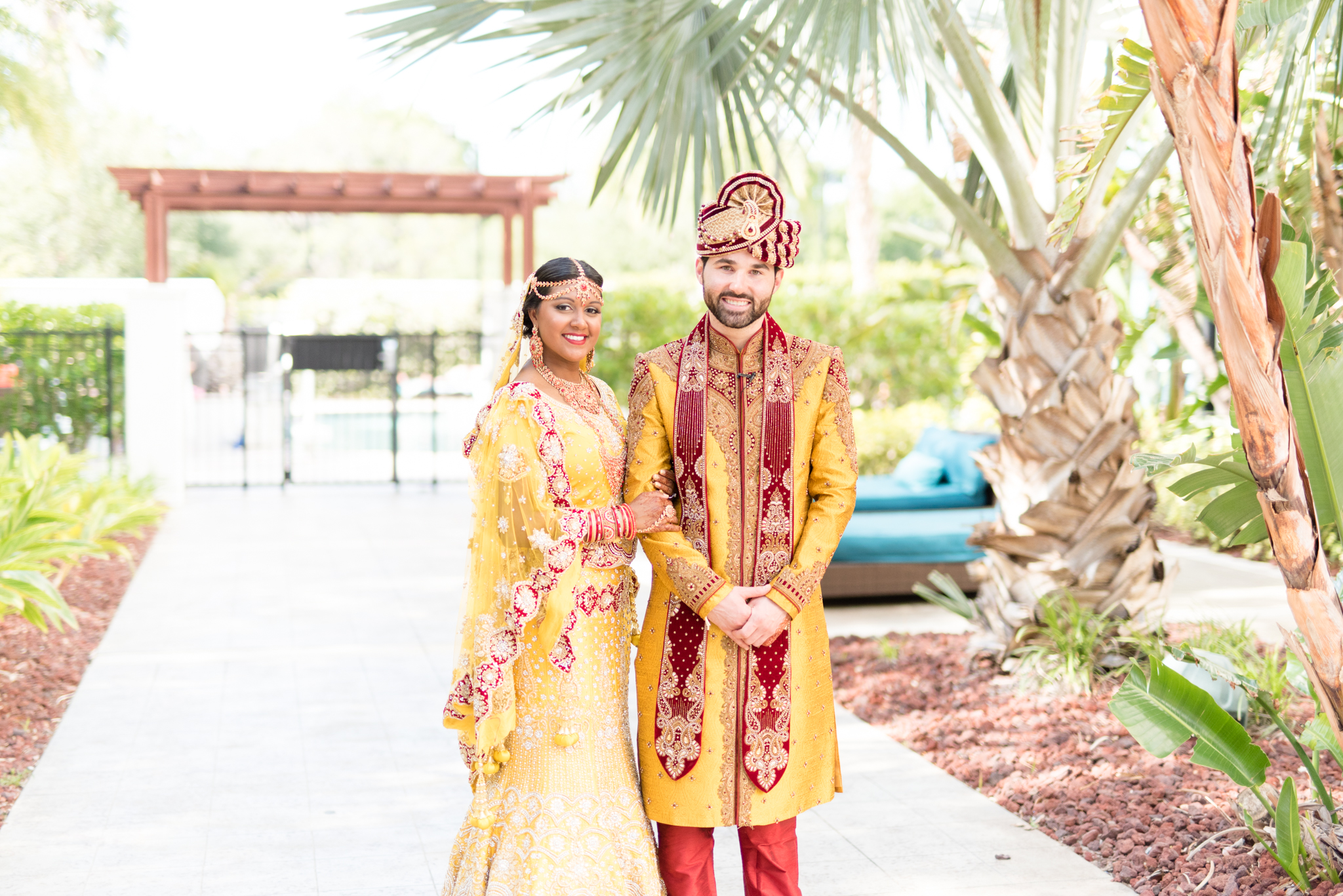 Indian Bride and groom smile at the camera.