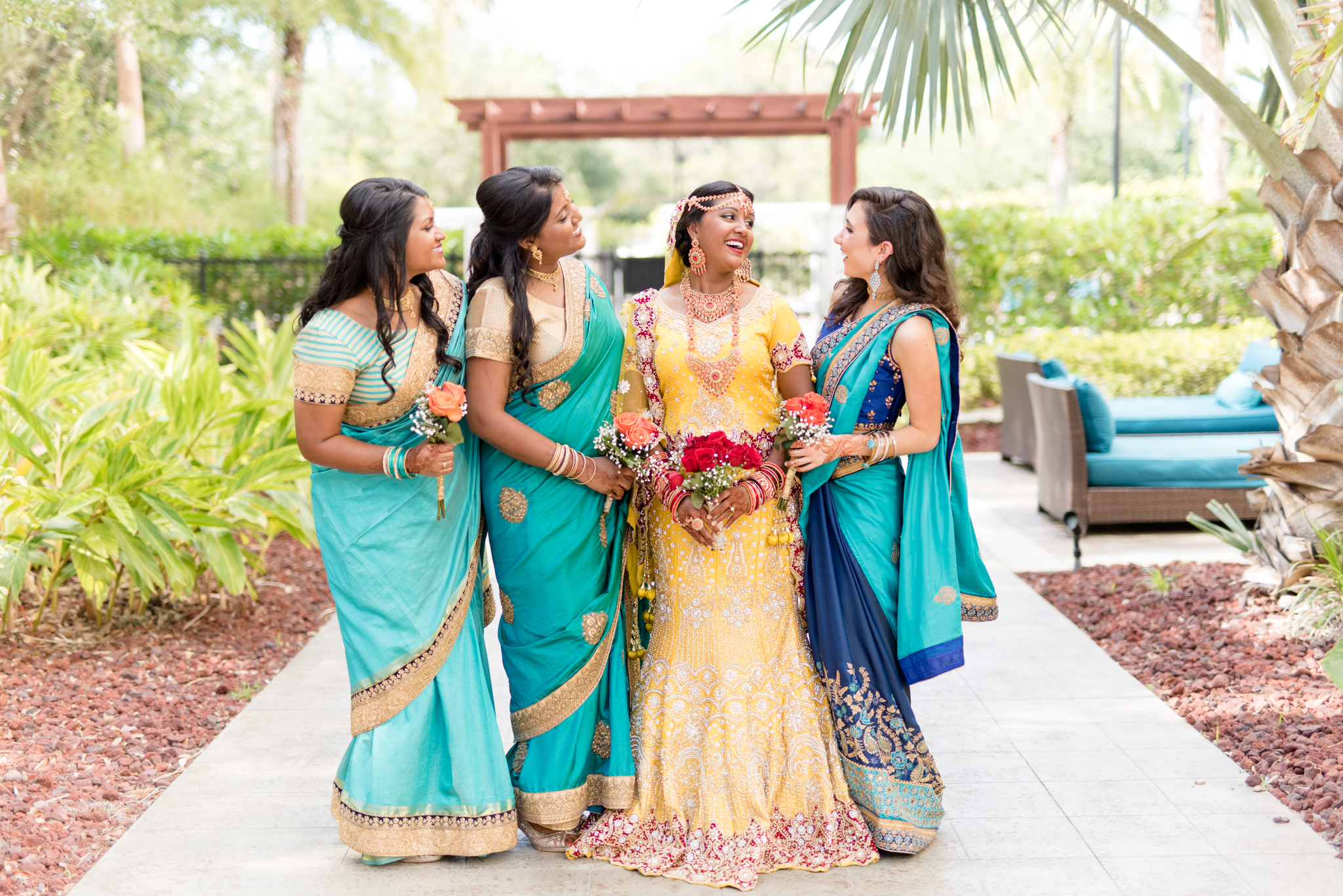 Bride laughs with her bridesmaids.