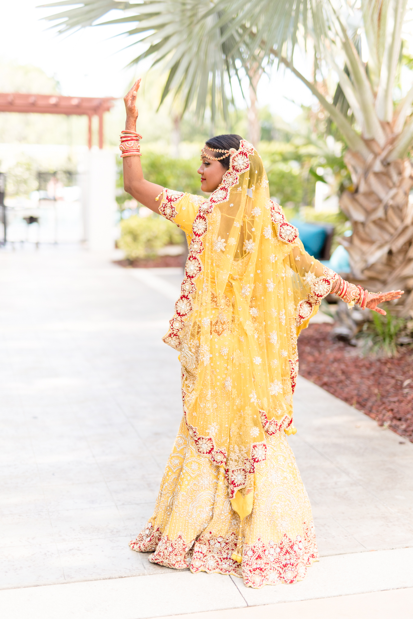 Bride poses in Indian wedding dress.