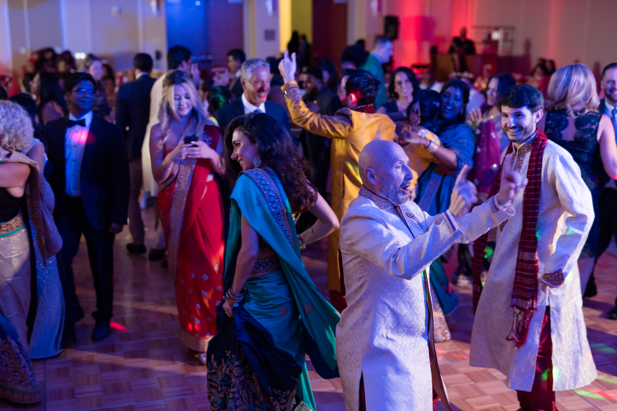 Guests dance at wedding reception.