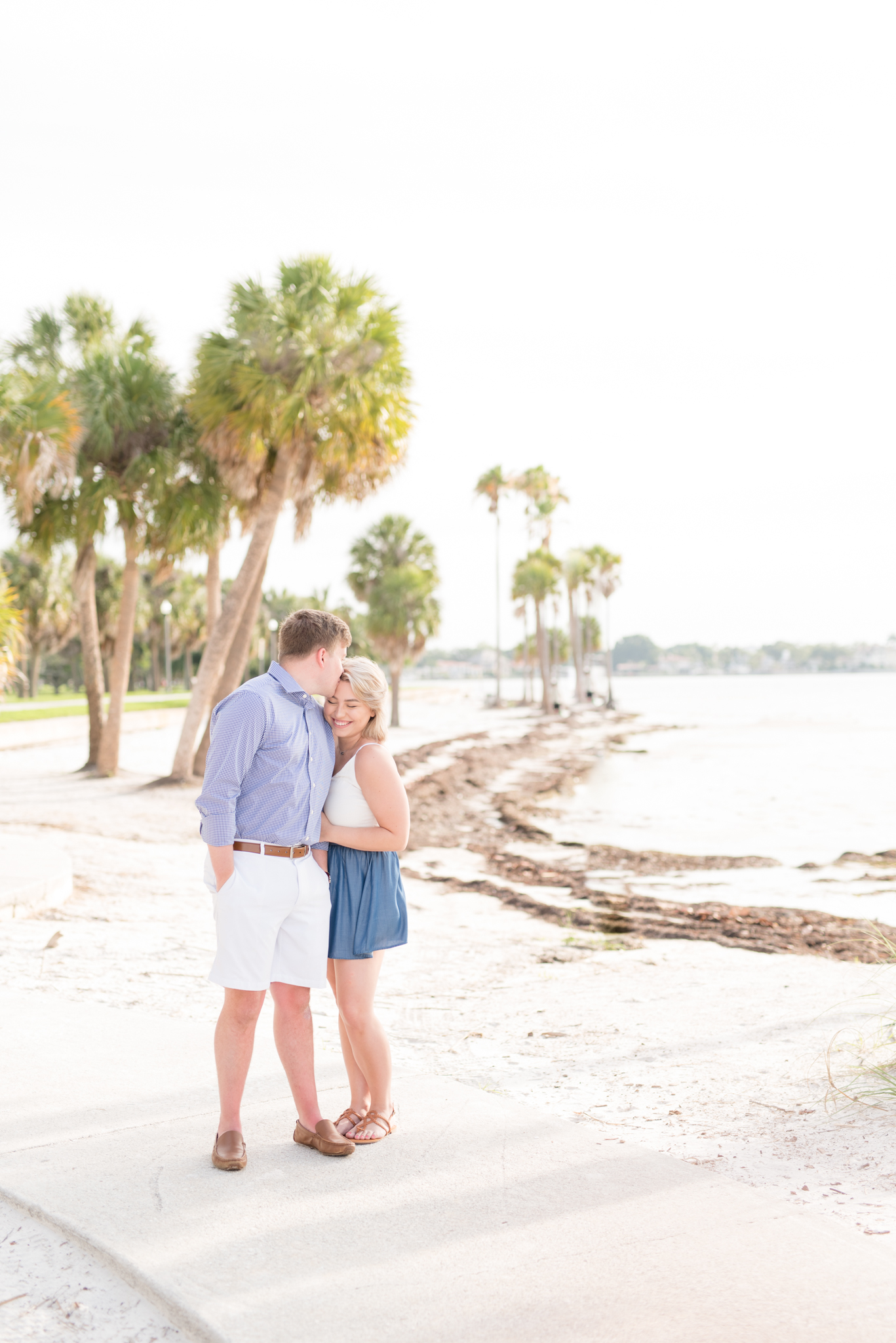 Couple snuggles on Florida beach.