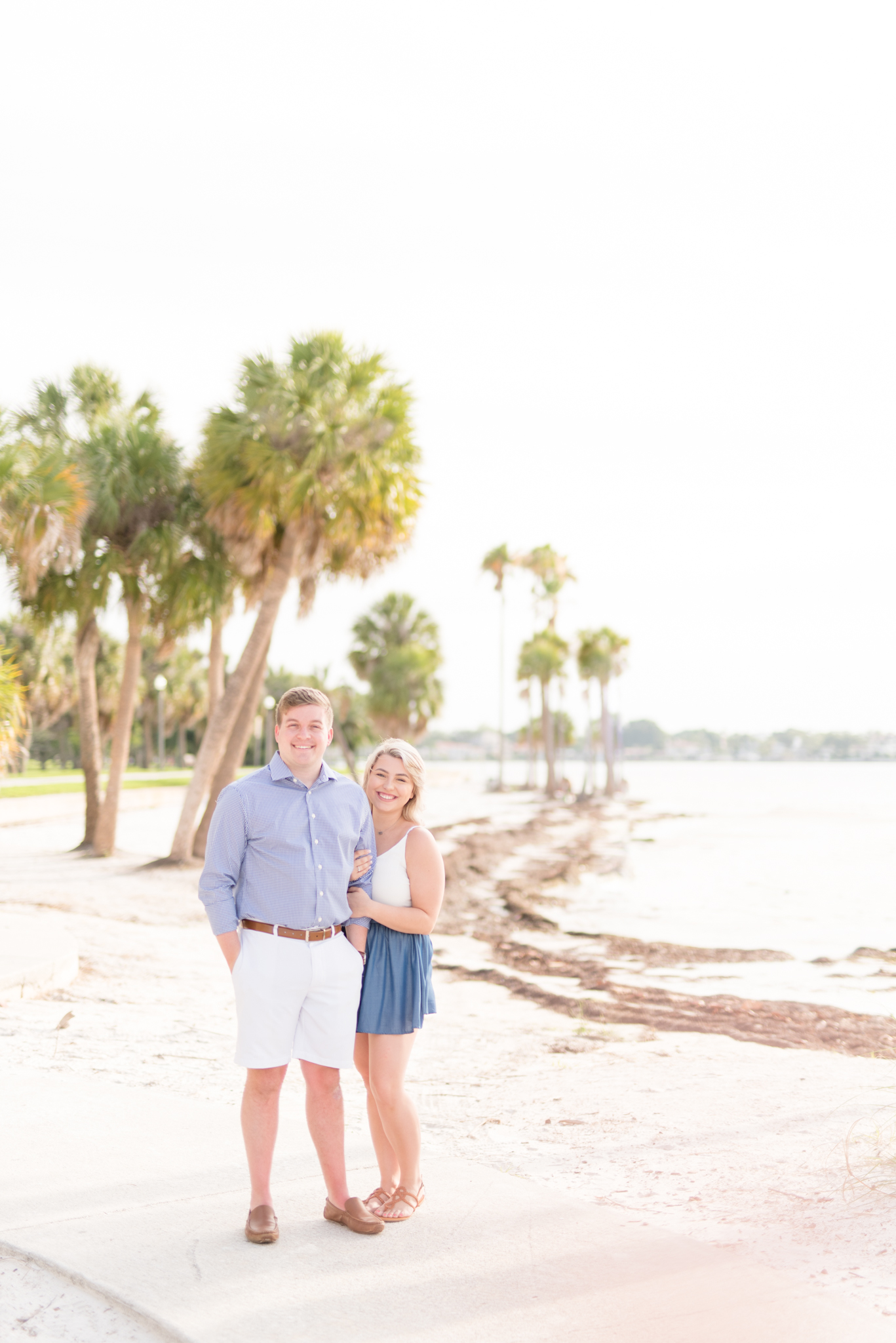 Couple smiles at camera on Florida beach.