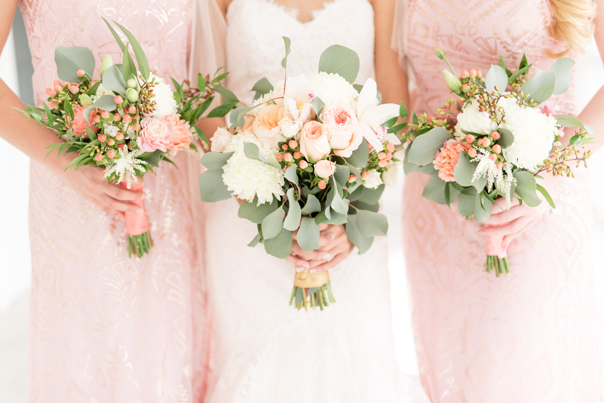 Tampa bride and bridesmaids hold bouquets.