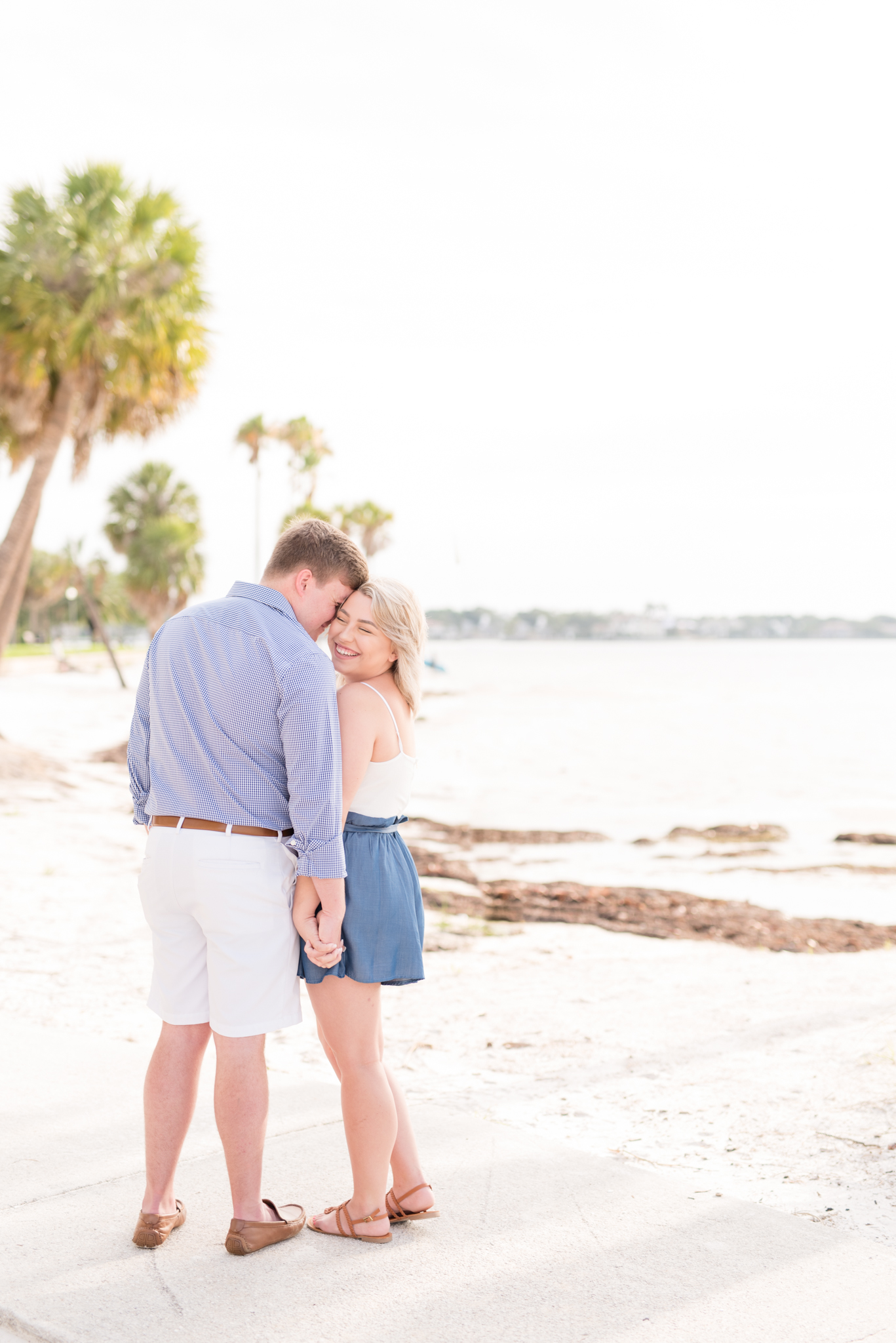 Couple hugs on Tampa beach.