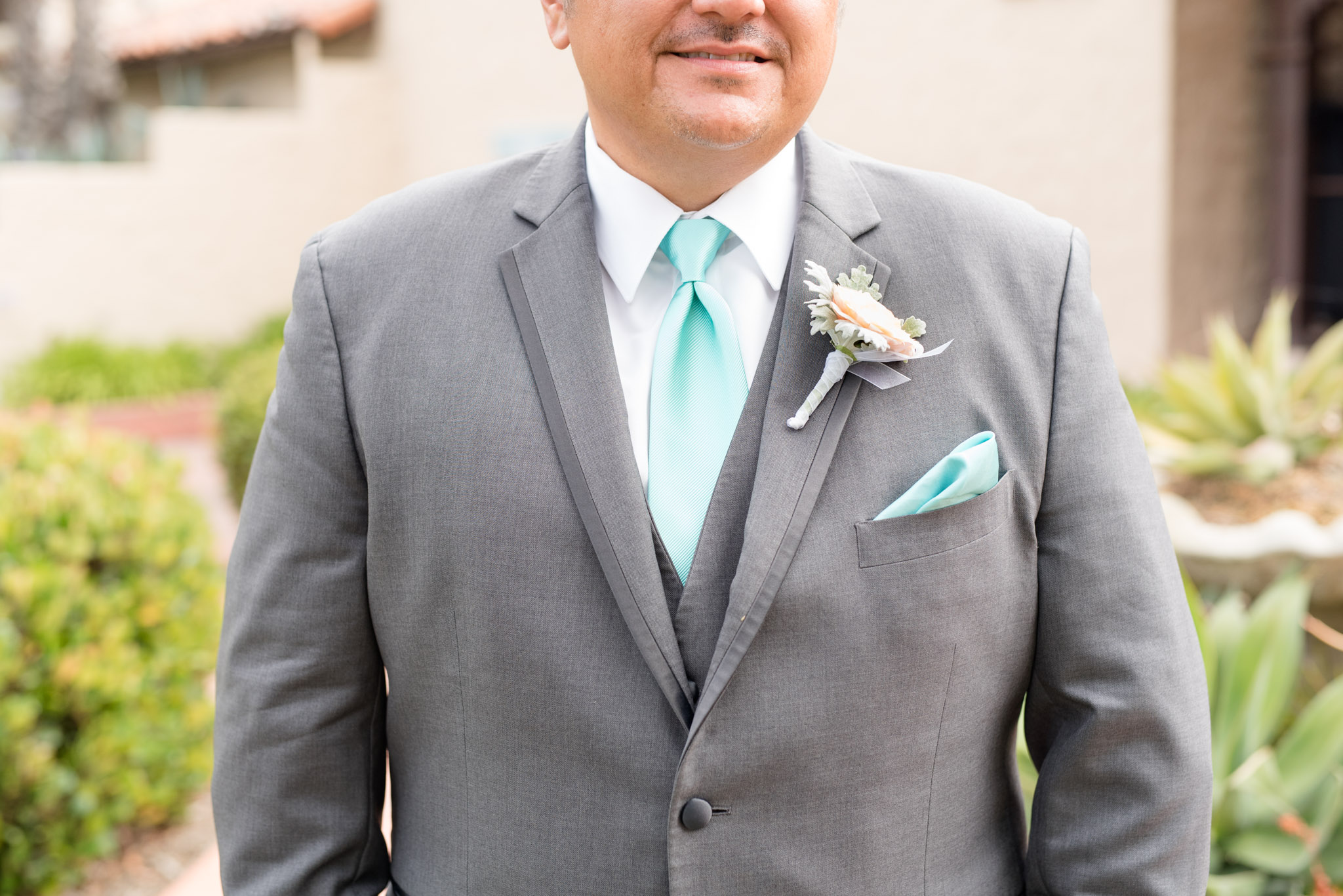 Groom's suit with spa blue tie.