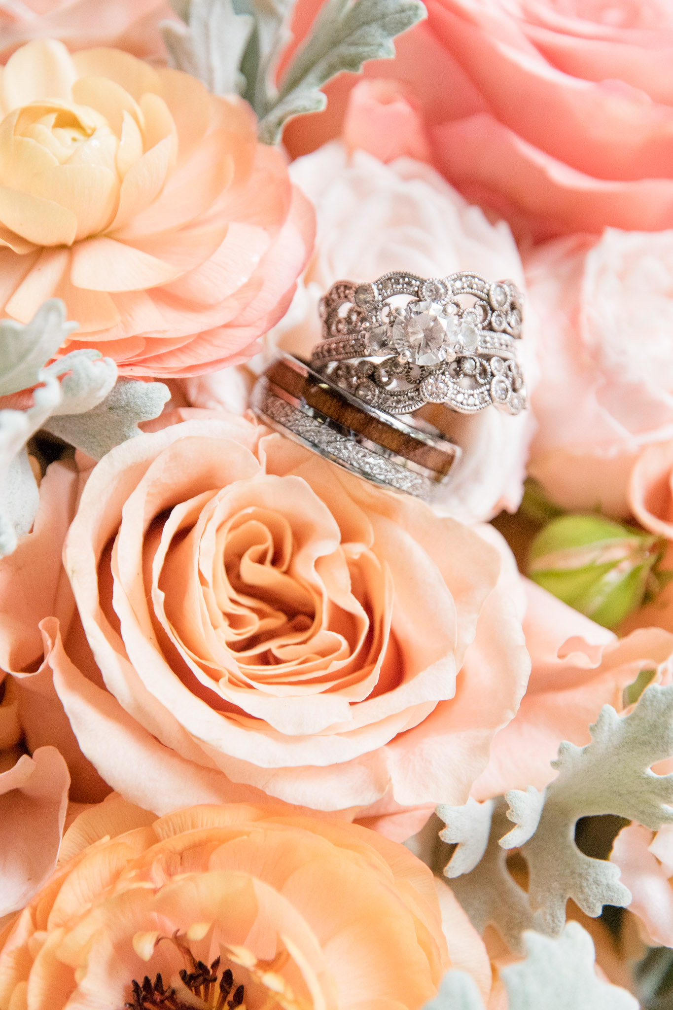 Wedding rings sit on flowers.