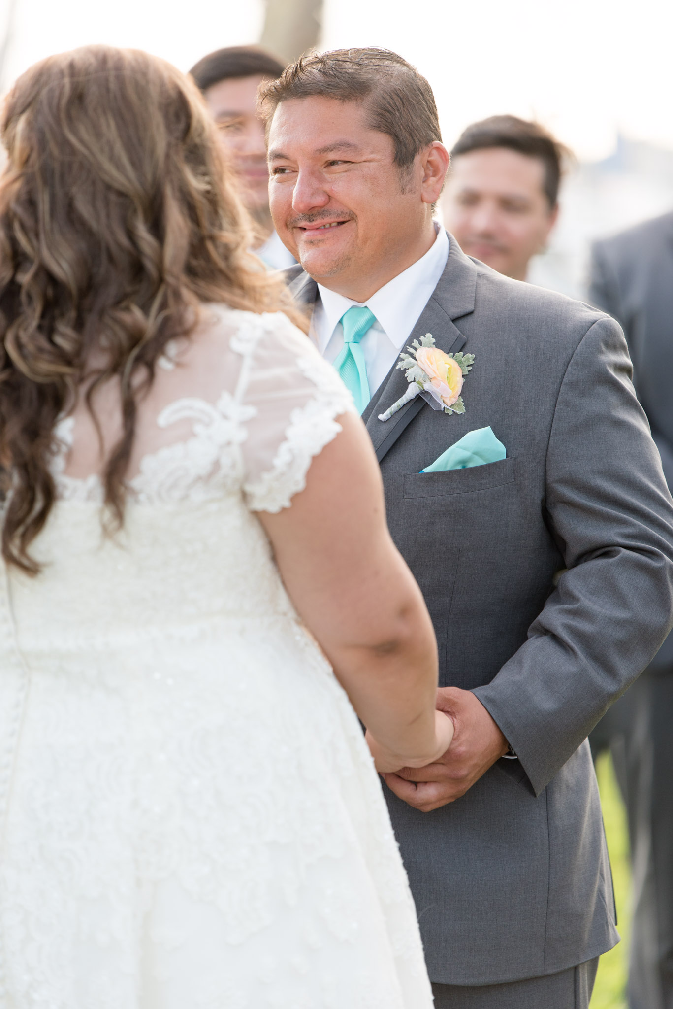 Groom smiles during wedding ceremony.