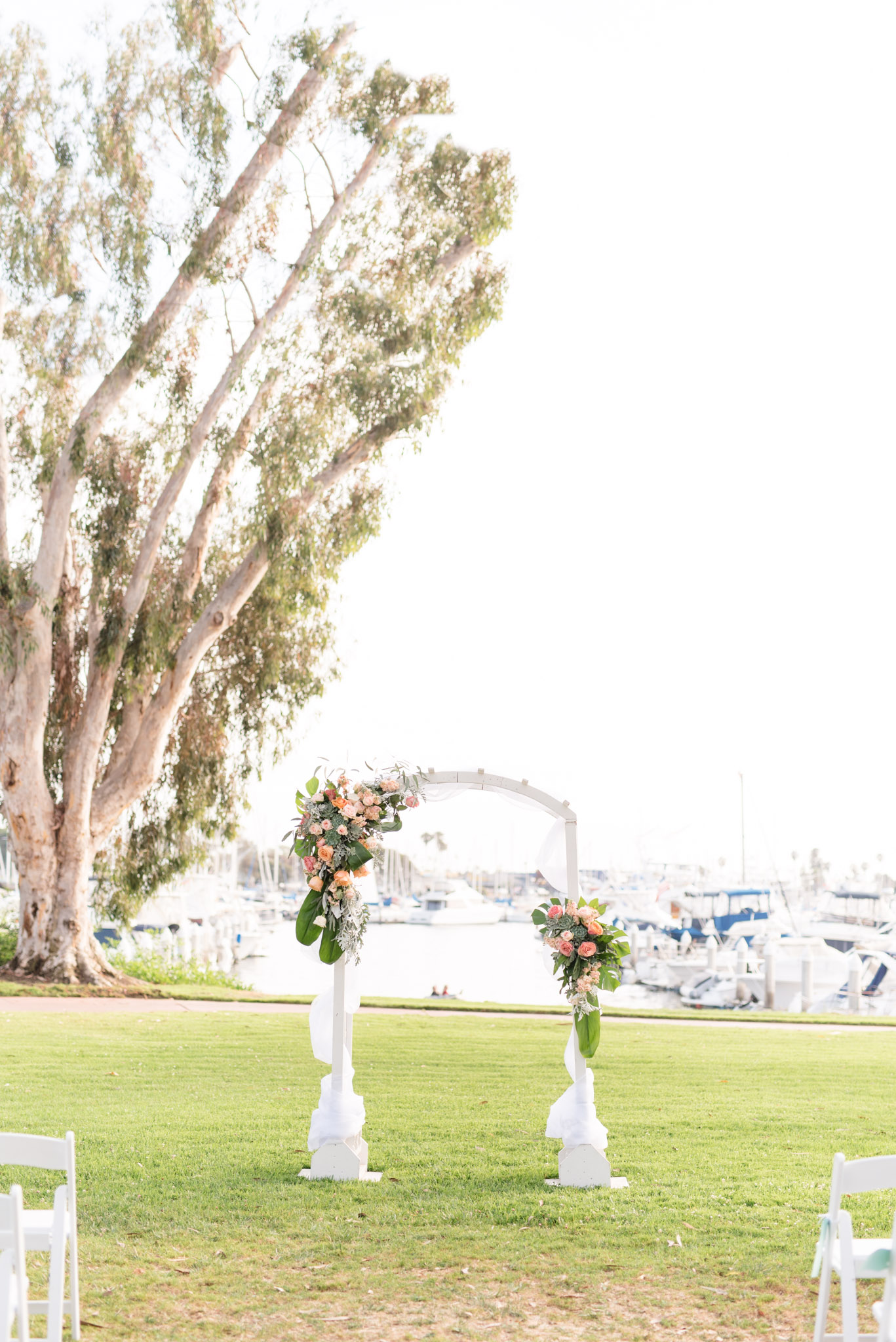 Wedding arch decorated with pink flowers.