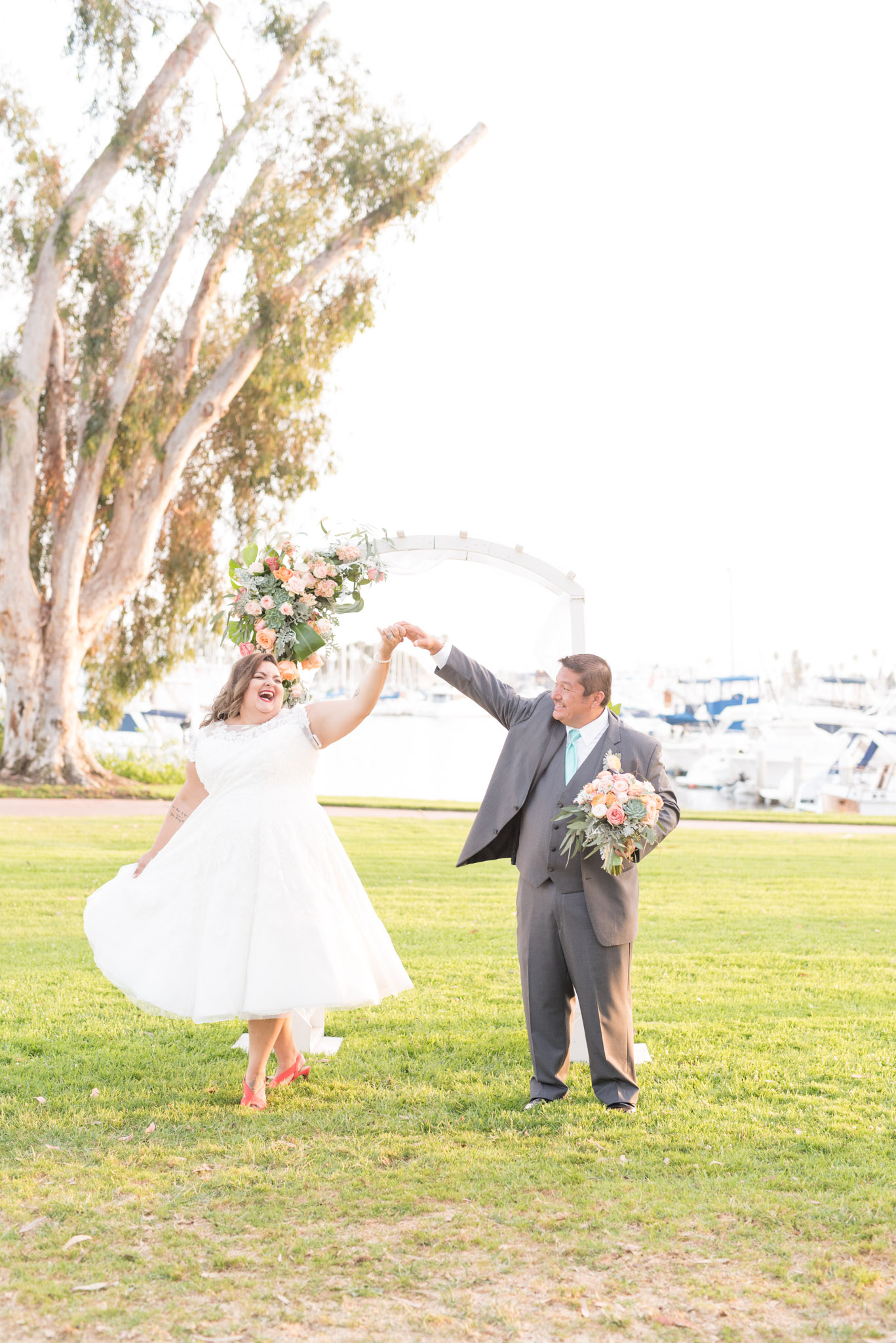 Groom twirls bride.