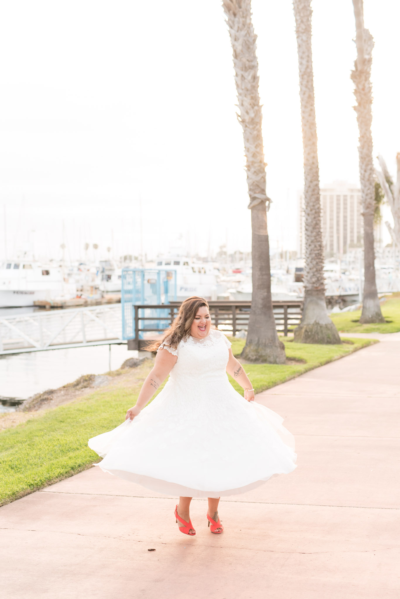 Bride twirls dress at sunset.