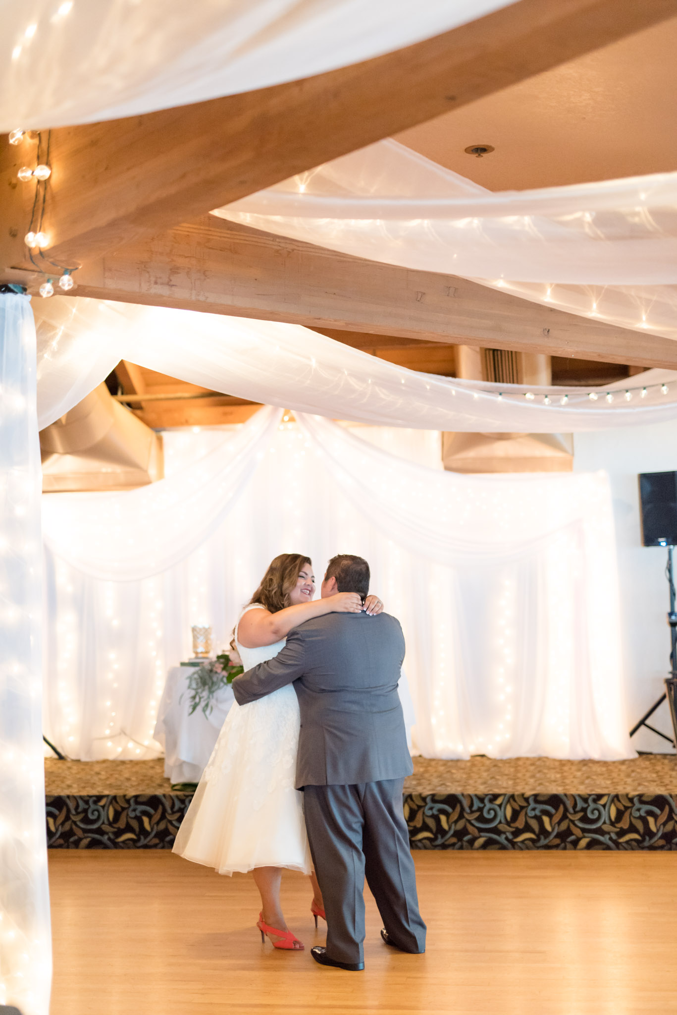 Bride and groom dance at wedding reception.