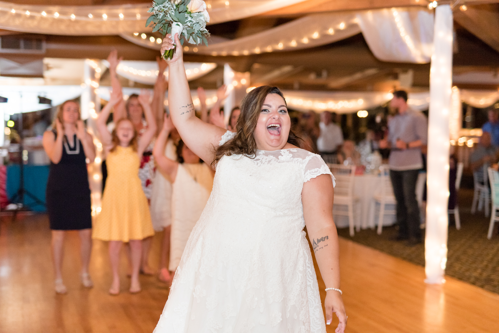 Bride tosses bouquet.