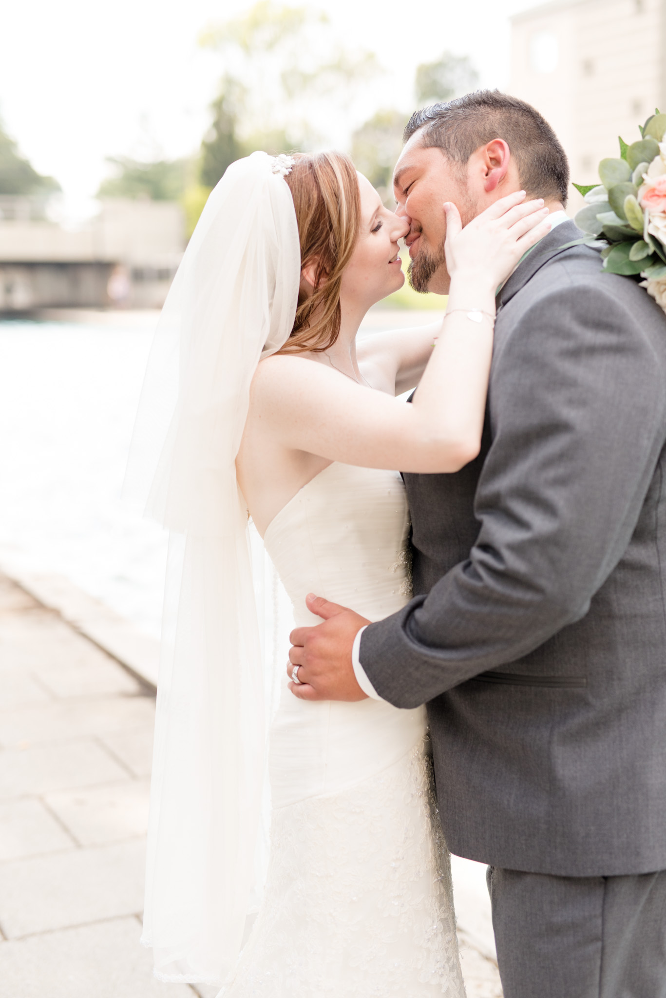 Bride and groom almost kiss on Indianapolis canal.