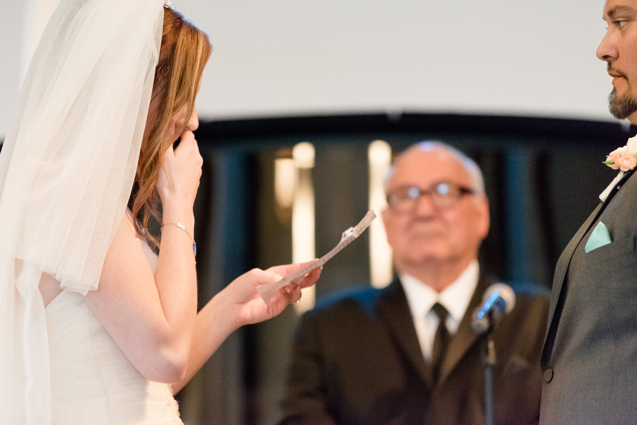 Bride cries during vows.
