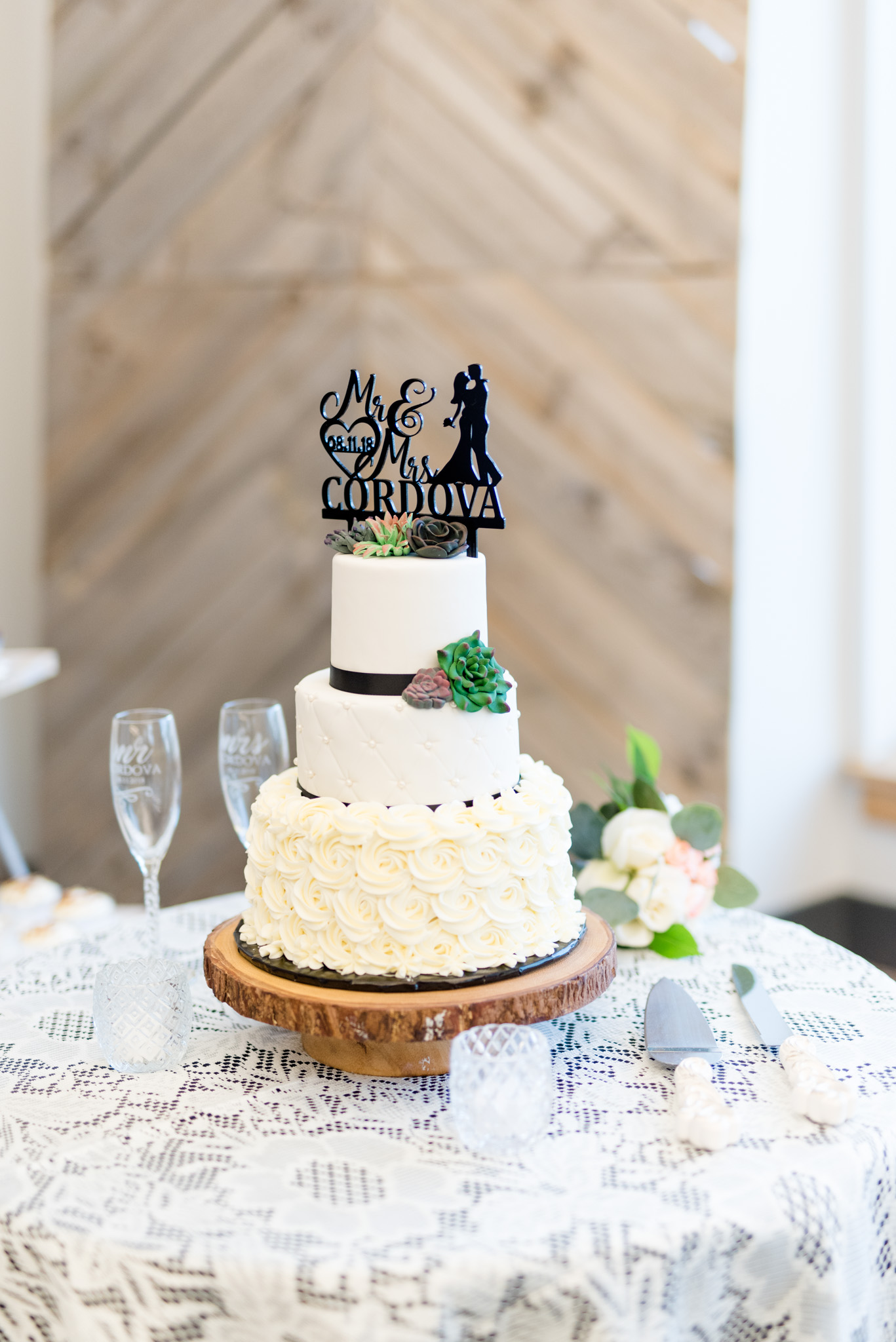 Wedding cake sits on cake stand.