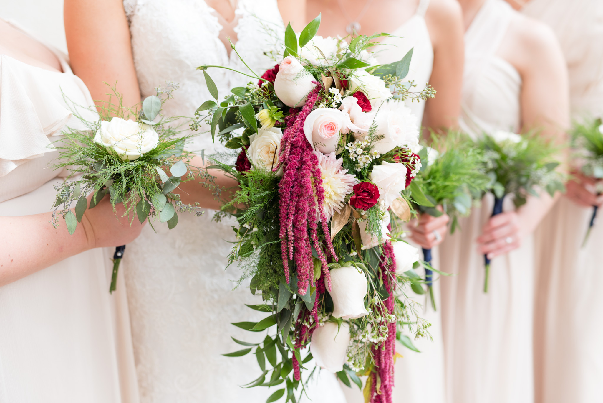 Bridal party holds bouquets.