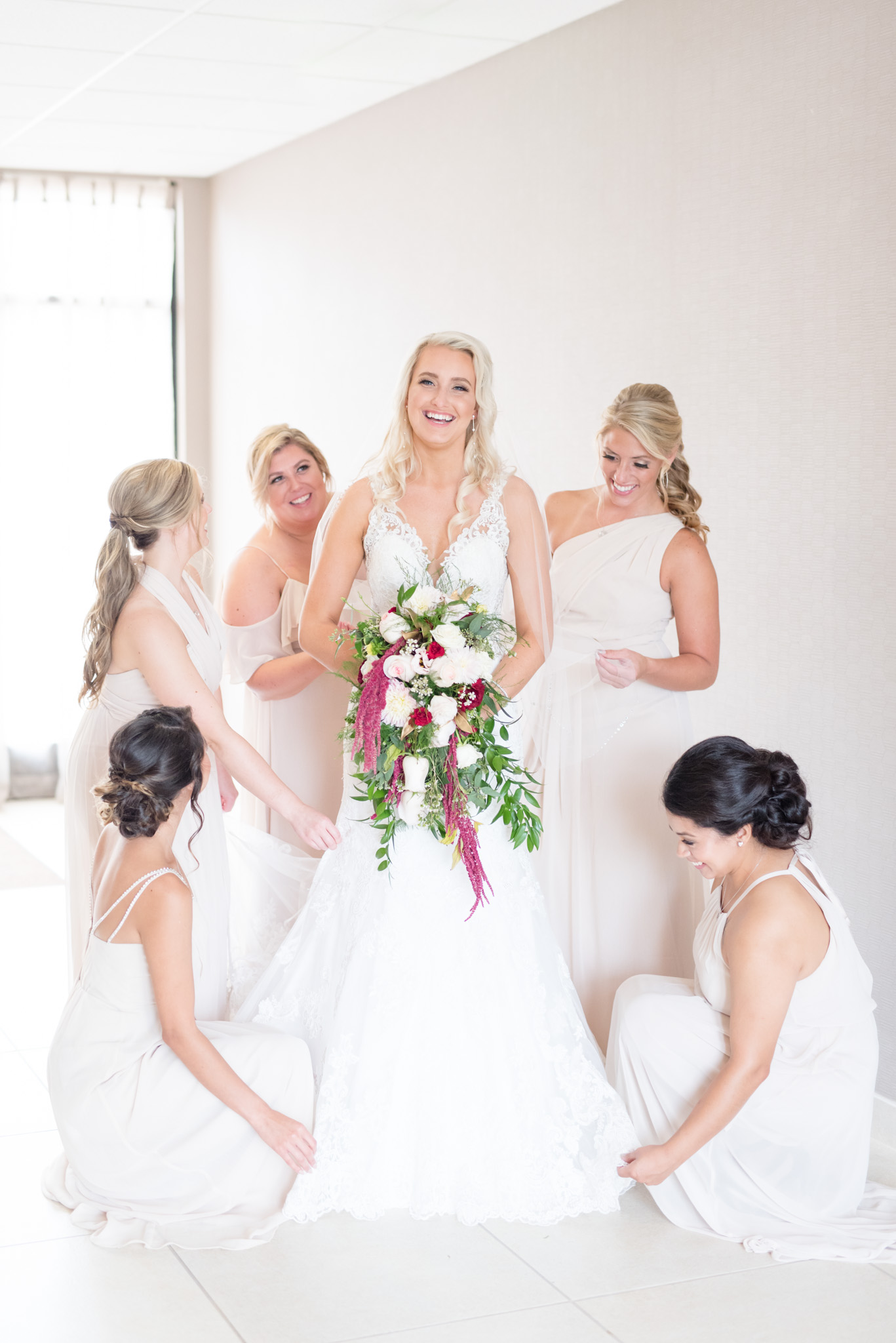 Bridesmaids help bride get ready.
