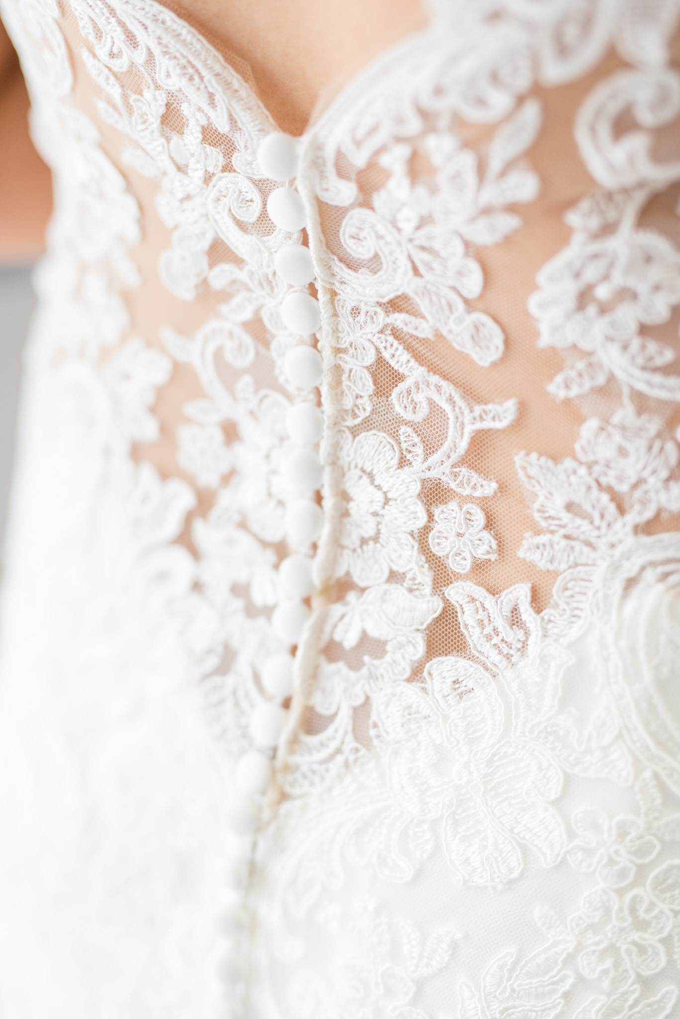 Lace buttons on back of wedding dress.