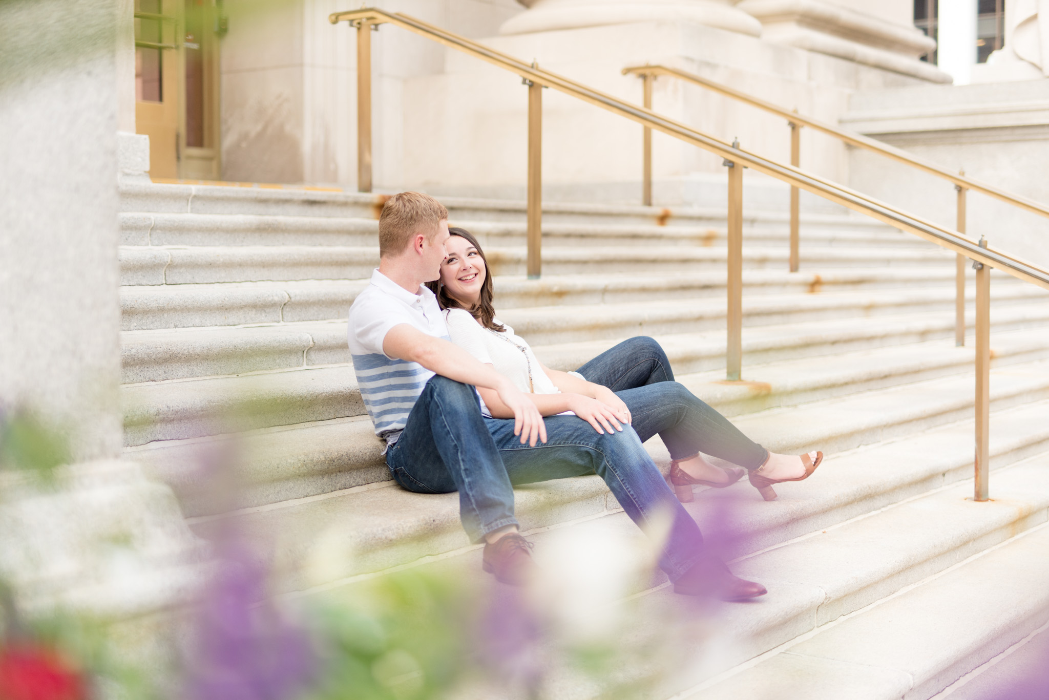 Couple sits on steps on Indianapolis courthouse.