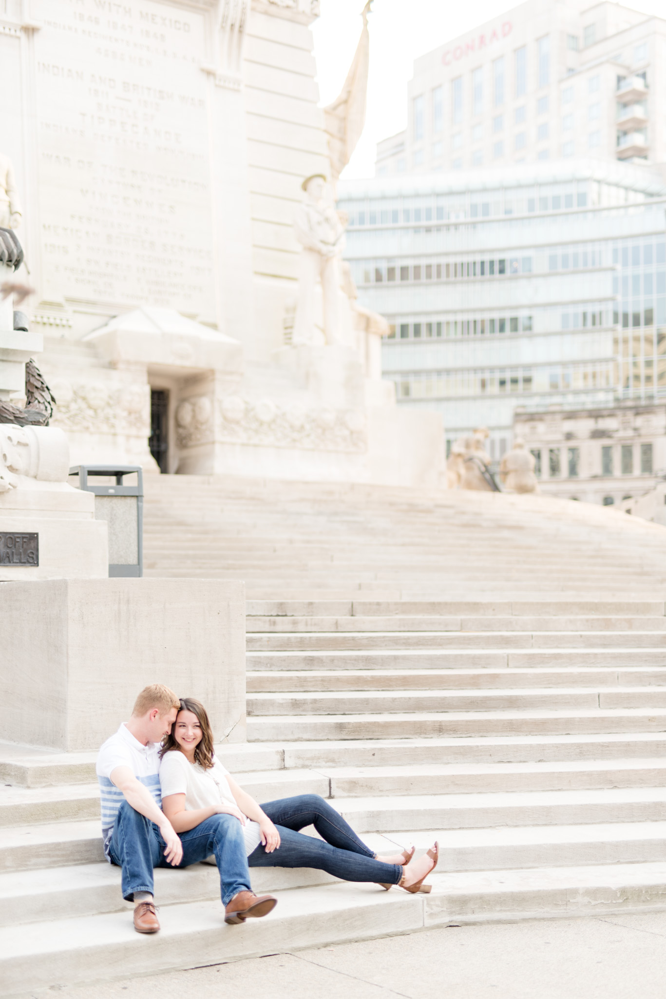 Couple snuggles at Indianapolis monument.