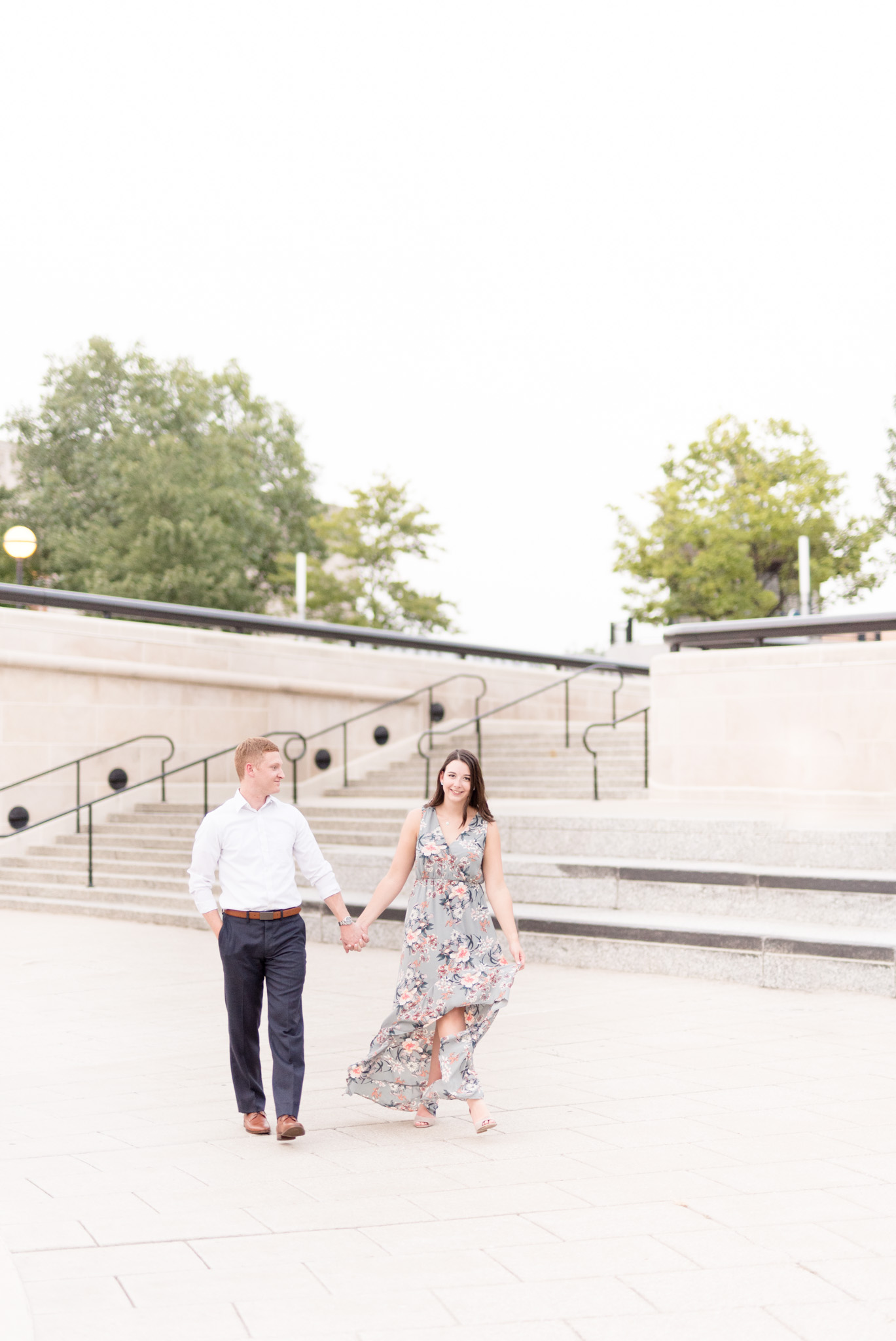 Engaged couple walks towards camera.