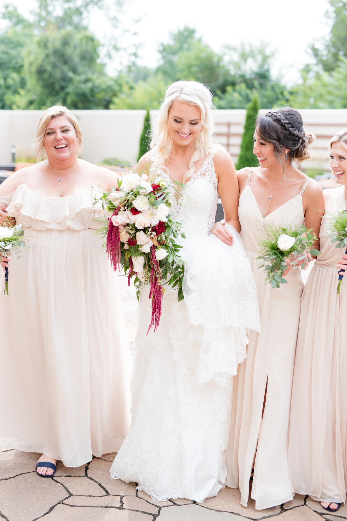 Bride and bridesmaids walk together.