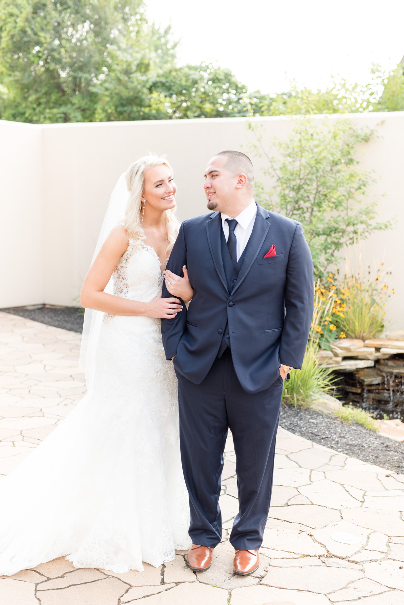 Bride and groom smile at each other.