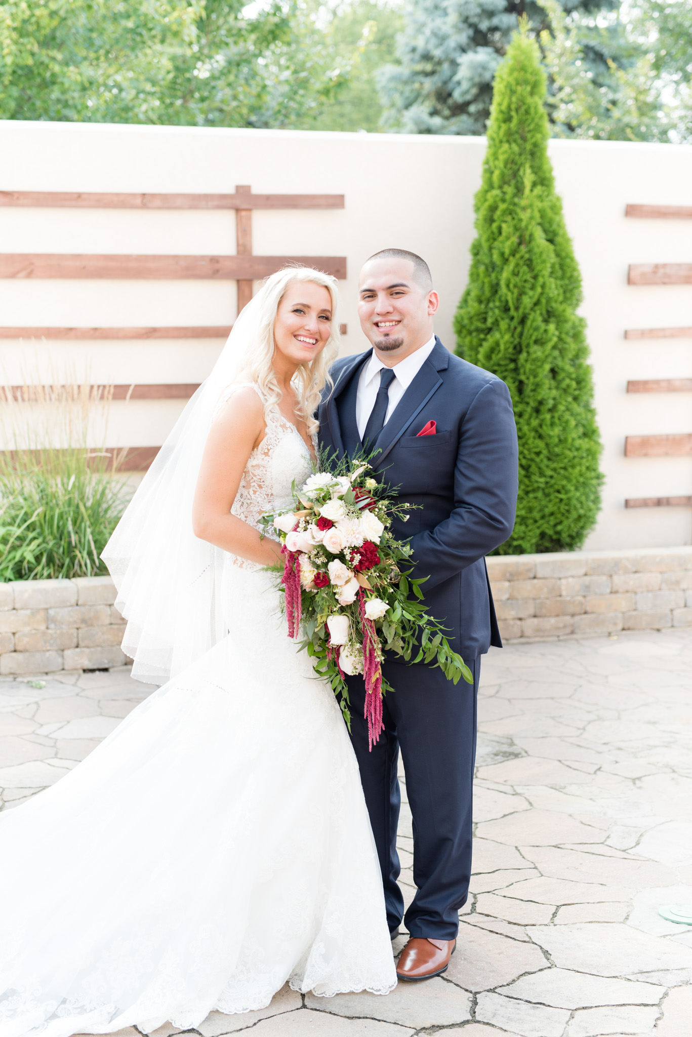 Bride and groom smile for pictures.