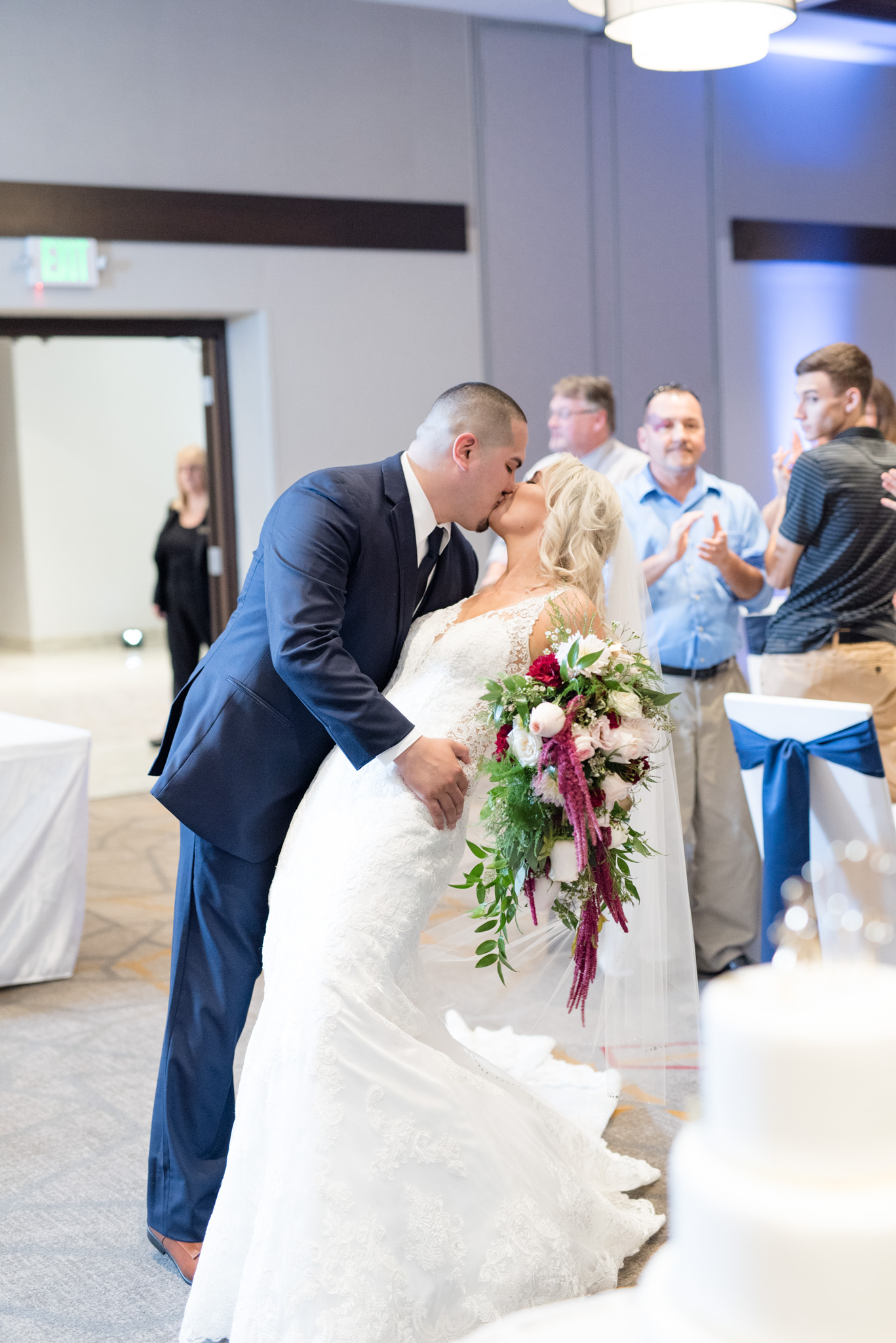Groom dips bride at wedding reception.