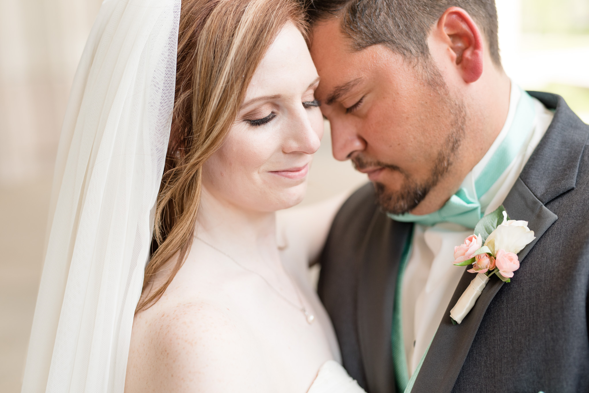 Bride and groom snuggle.