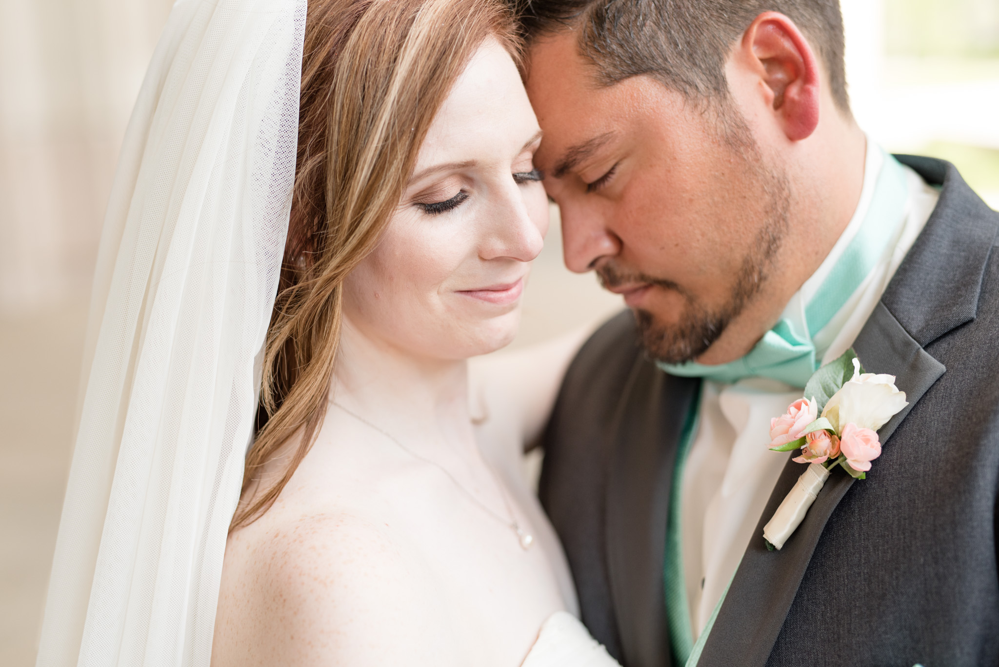 Bride and groom snuggle.