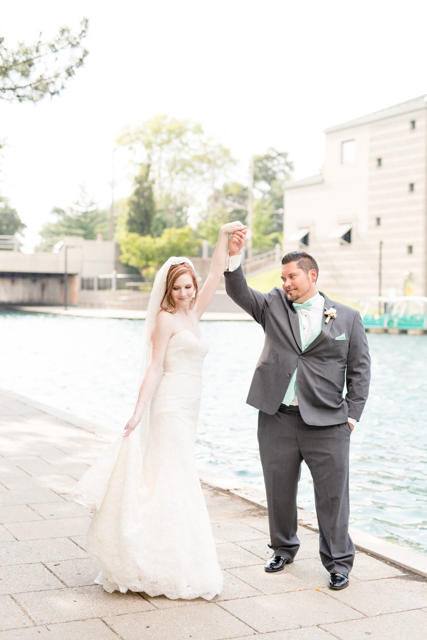 Groom twirls bride on Indianapolis canal.