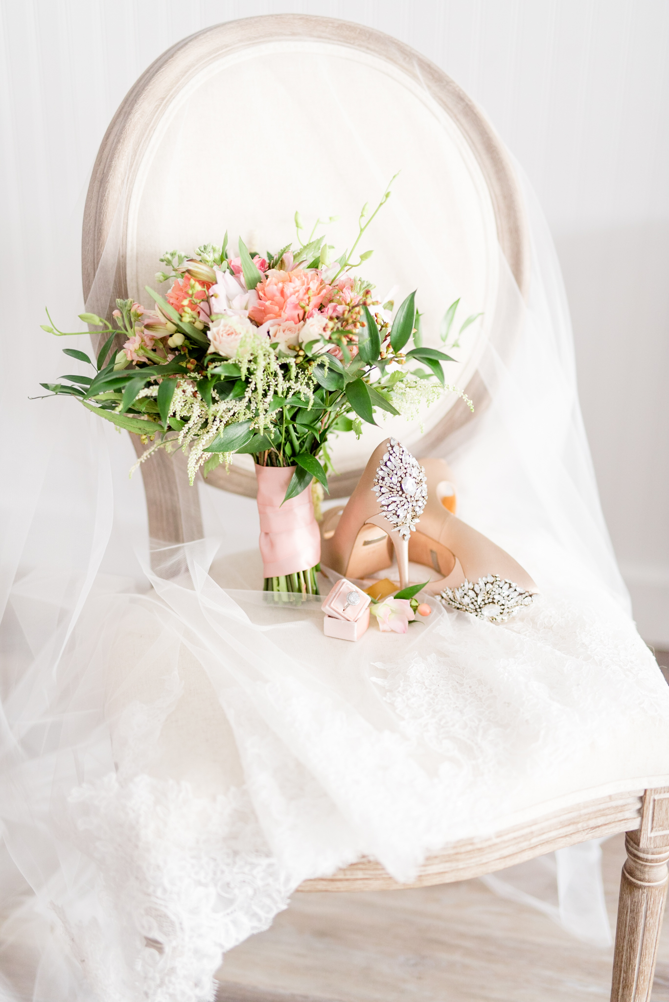 Wedding Shoes and flowers sit on chair