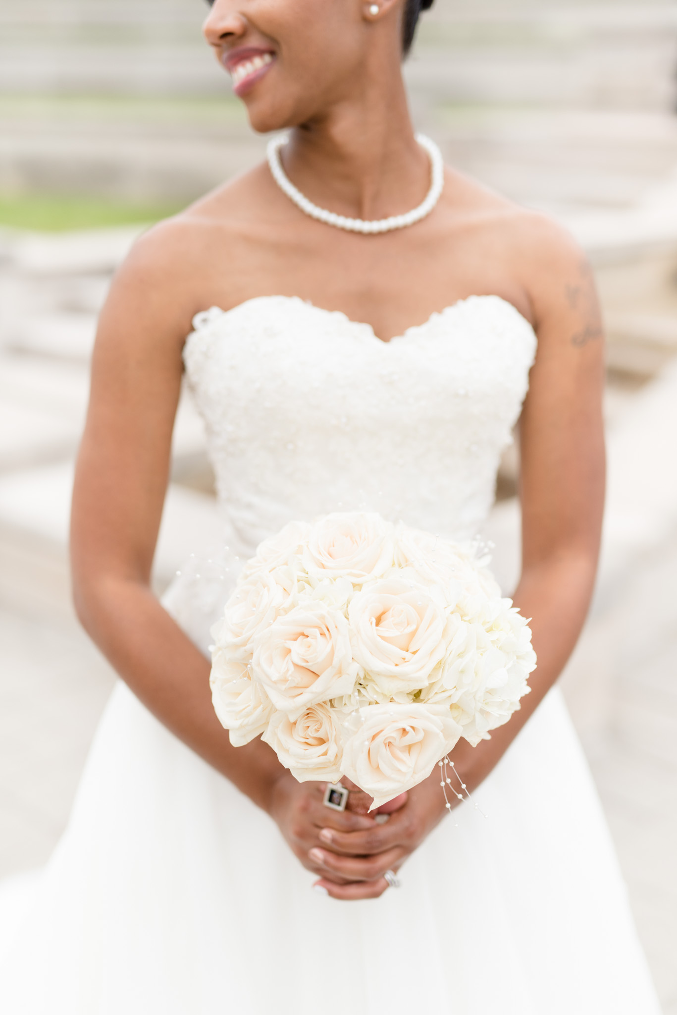 Bride holds flowers.