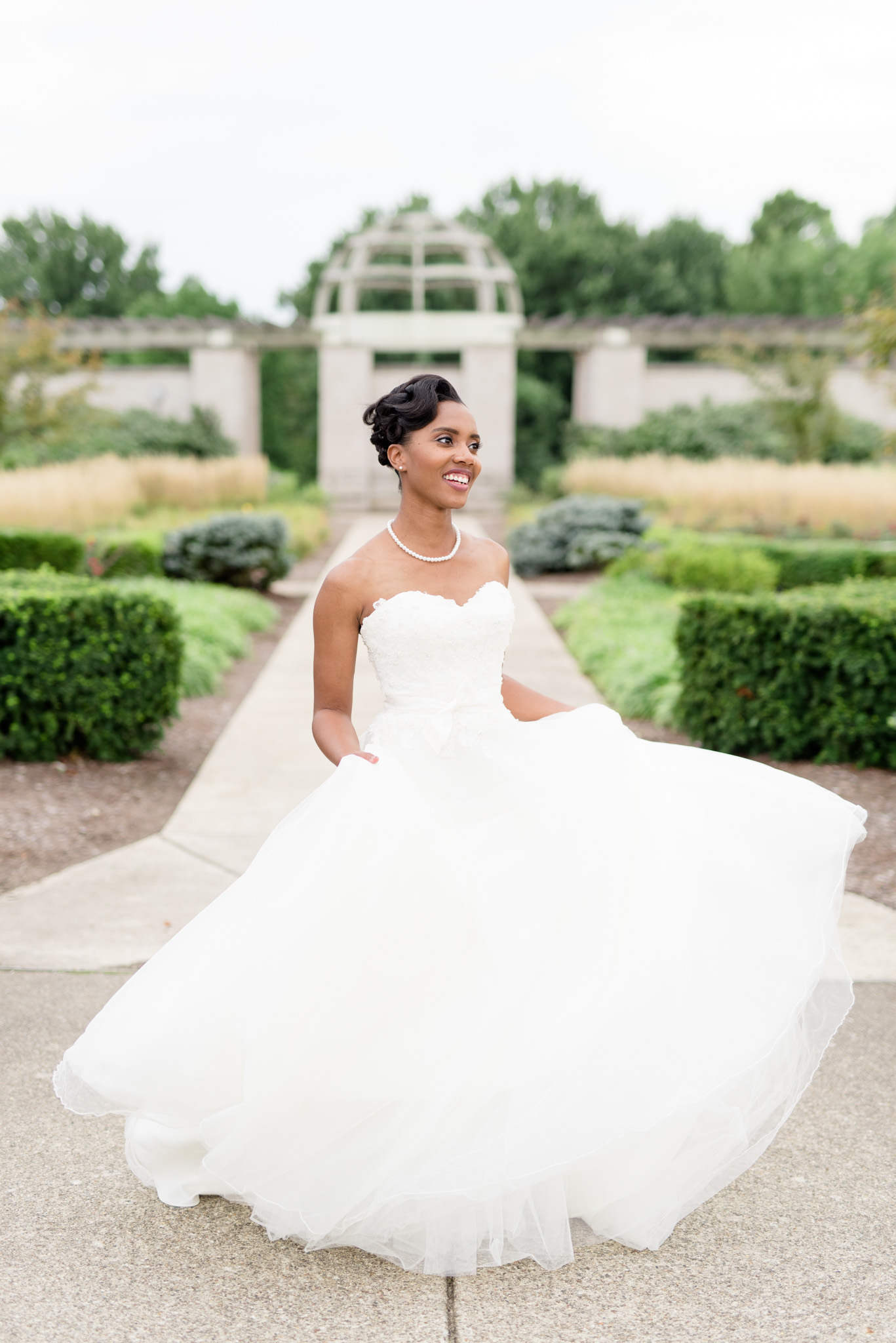 Bride twirls in garden.