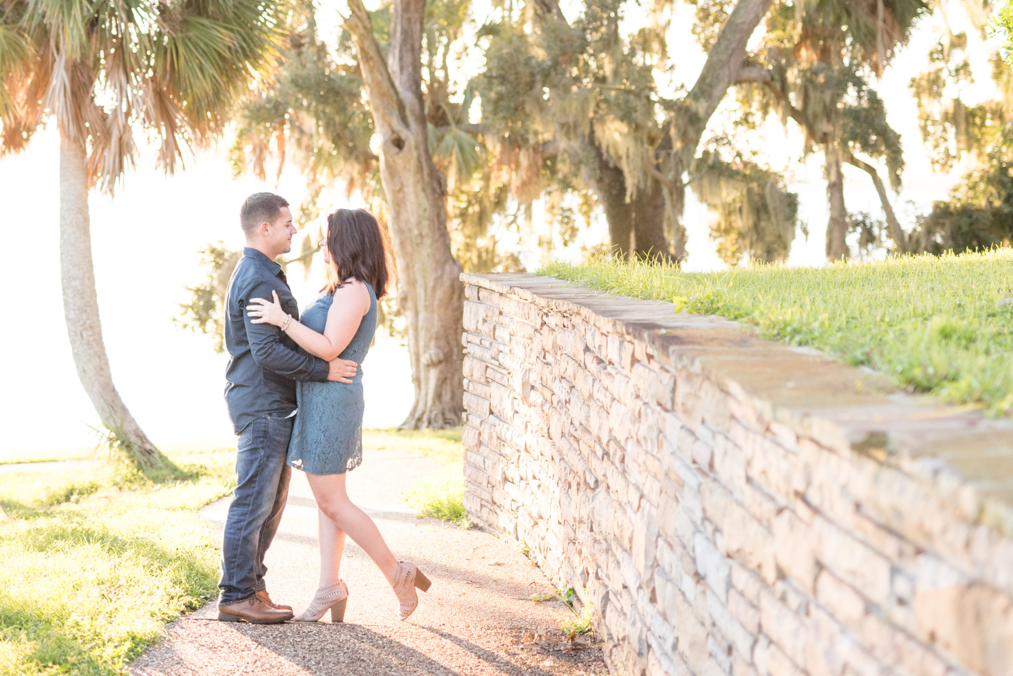 Couple looks at each other in park.