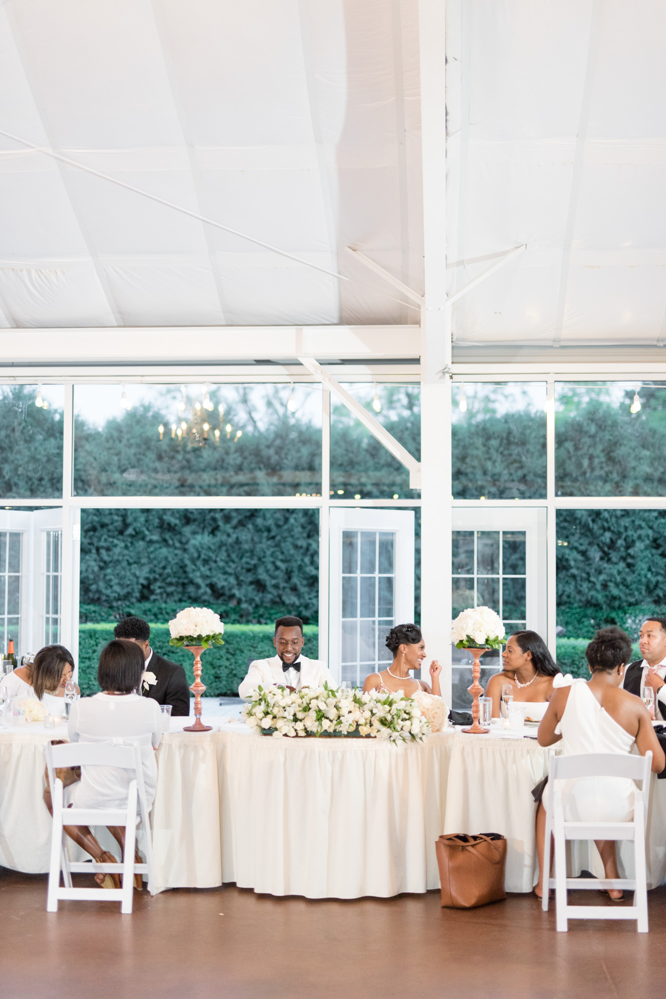 Bride and groom sit at head table.